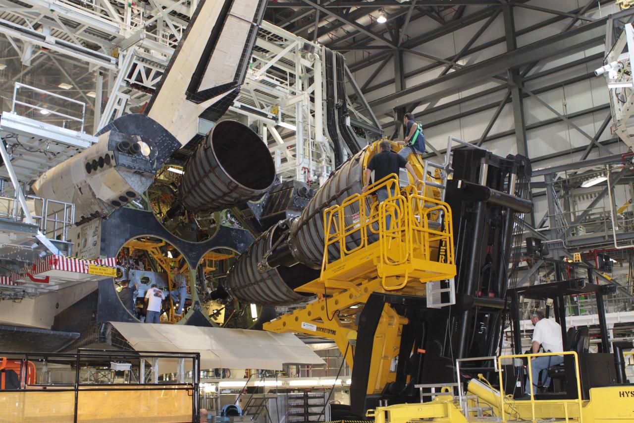 CAPE CANAVERAL, Fla. –Inside Orbiter Processing Facility-2 at NASA’s Kennedy Space Center in Florida, United Space Alliance technicians on a Hyster forklift move replica shuttle main engine 2, or RSME 2, closer for installation on space shuttle Endeavour. The orbiter is surrounded by work platforms allowing access to all areas of the spacecraft. The work is part of Transition and Retirement of the remaining space shuttles, Endeavour and Atlantis. Endeavour is being prepared for public display at the California Science Center in Los Angeles. Its ferry flight to California is targeted for mid-September. Endeavour was the last space shuttle added to NASA’s orbiter fleet. Over the course of its 19-year career, Endeavour spent 299 days in space during 25 missions. For more information, visit http://www.nasa.gov/shuttle. Photo credit: NASA/David Lee