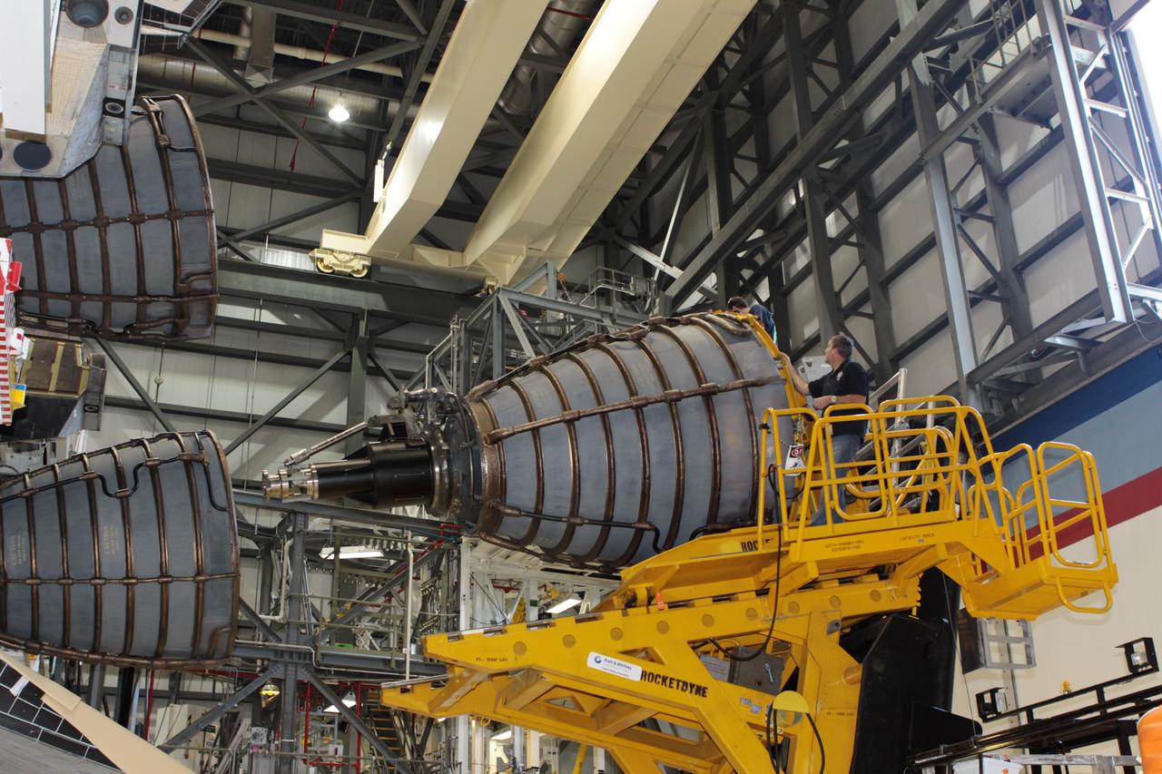 CAPE CANAVERAL, Fla. – Inside Orbiter Processing Facility-2 at NASA’s Kennedy Space Center in Florida, United Space Alliance technicians on a Hyster forklift move replica shuttle main engine 2, or RSME 2, closer for installation on space shuttle Endeavour. The orbiter is surrounded by work platforms allowing access to all areas of the spacecraft. The work is part of Transition and Retirement of the remaining space shuttles, Endeavour and Atlantis. Endeavour is being prepared for public display at the California Science Center in Los Angeles. Its ferry flight to California is targeted for mid-September. Endeavour was the last space shuttle added to NASA’s orbiter fleet. Over the course of its 19-year career, Endeavour spent 299 days in space during 25 missions. For more information, visit http://www.nasa.gov/shuttle. Photo credit: NASA/David Lee