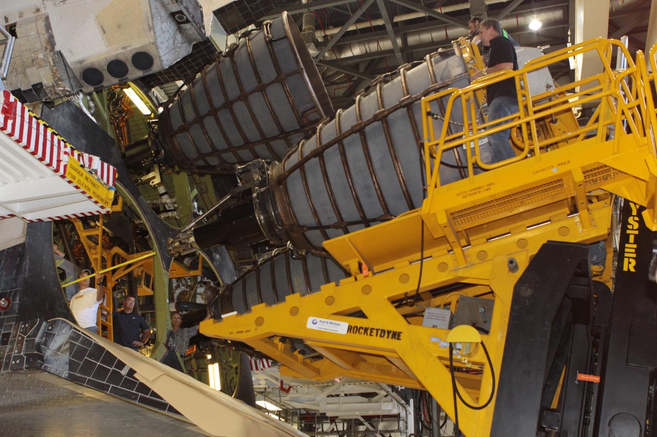 CAPE CANAVERAL, Fla. – Inside Orbiter Processing Facility-2 at NASA’s Kennedy Space Center in Florida, United Space Alliance technicians on a Hyster forklift move replica shuttle main engine 2, or RSME 2, closer for installation on space shuttle Endeavour. The orbiter is surrounded by work platforms allowing access to all areas of the spacecraft. The work is part of Transition and Retirement of the remaining space shuttles, Endeavour and Atlantis. Endeavour is being prepared for public display at the California Science Center in Los Angeles. Its ferry flight to California is targeted for mid-September. Endeavour was the last space shuttle added to NASA’s orbiter fleet. Over the course of its 19-year career, Endeavour spent 299 days in space during 25 missions. For more information, visit http://www.nasa.gov/shuttle. Photo credit: NASA/David Lee