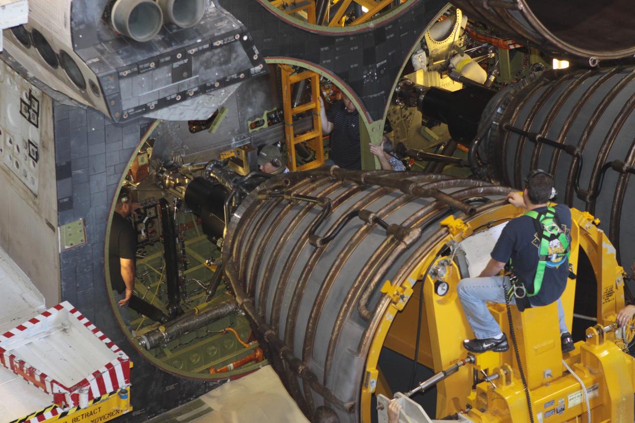 CAPE CANAVERAL, Fla. – Inside Orbiter Processing Facility-2 at NASA’s Kennedy Space Center in Florida, a United Space Alliance technician on a Hyster forklift guides replica shuttle main engine 2, or RSME 2, closer for installation on space shuttle Endeavour. The orbiter is surrounded by work platforms allowing access to all areas of the spacecraft. The work is part of Transition and Retirement of the remaining space shuttles, Endeavour and Atlantis. Endeavour is being prepared for public display at the California Science Center in Los Angeles. Its ferry flight to California is targeted for mid-September. Endeavour was the last space shuttle added to NASA’s orbiter fleet. Over the course of its 19-year career, Endeavour spent 299 days in space during 25 missions. For more information, visit http://www.nasa.gov/shuttle. Photo credit: NASA/David Lee