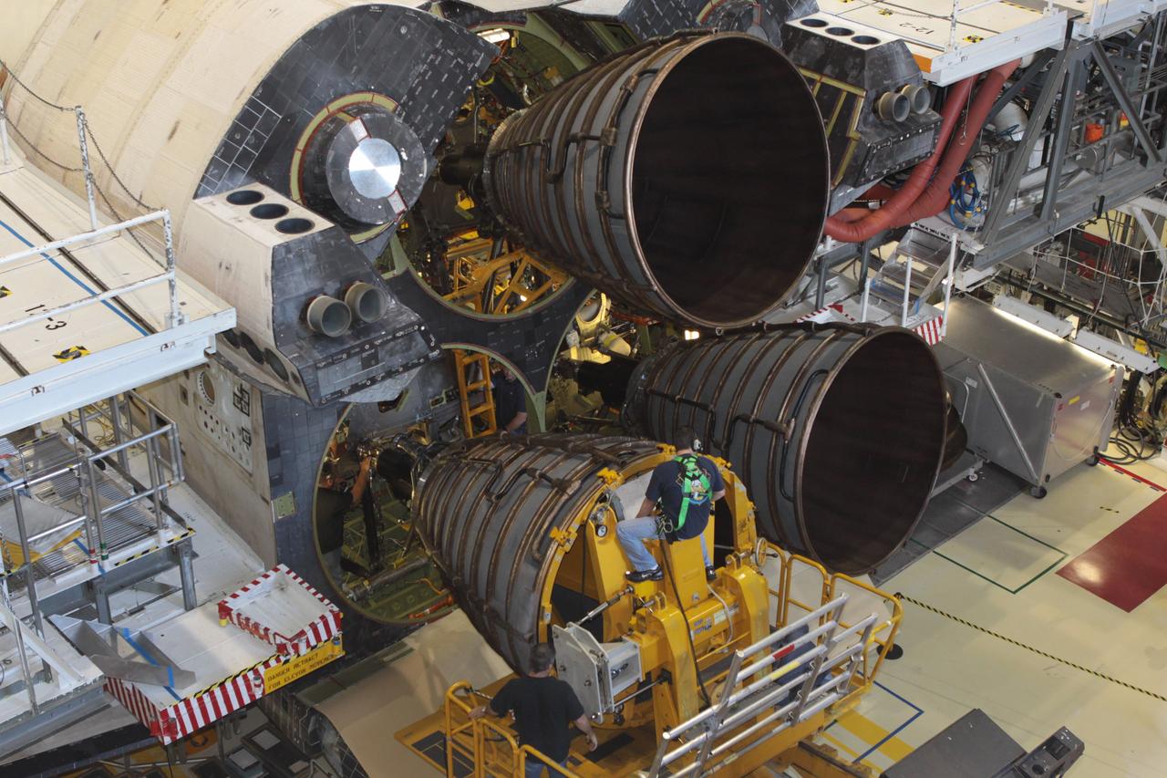CAPE CANAVERAL, Fla. – Inside Orbiter Processing Facility-2 at NASA’s Kennedy Space Center in Florida, a United Space Alliance technician on a Hyster forklift guides replica shuttle main engine 2, or RSME 2, toward space shuttle Endeavour as USA technicians in the aft area monitor the progress. The orbiter is surrounded by work platforms allowing access to all areas of the spacecraft. The work is part of Transition and Retirement of the remaining space shuttles, Endeavour and Atlantis. Endeavour is being prepared for public display at the California Science Center in Los Angeles. Its ferry flight to California is targeted for mid-September. Endeavour was the last space shuttle added to NASA’s orbiter fleet. Over the course of its 19-year career, Endeavour spent 299 days in space during 25 missions. For more information, visit http://www.nasa.gov/shuttle. Photo credit: NASA/David Lee