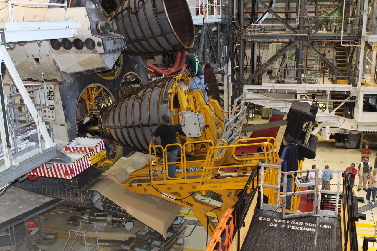 CAPE CANAVERAL, Fla. – Inside Orbiter Processing Facility-2 at NASA’s Kennedy Space Center in Florida, United Space Alliance technicians on a Hyster forklift guide replica shuttle main engine 2, or RSME 2, closer for installation on space shuttle Endeavour. The orbiter is surrounded by work platforms allowing access to all areas of the spacecraft. The work is part of Transition and Retirement of the remaining space shuttles, Endeavour and Atlantis. Endeavour is being prepared for public display at the California Science Center in Los Angeles. Its ferry flight to California is targeted for mid-September. Endeavour was the last space shuttle added to NASA’s orbiter fleet. Over the course of its 19-year career, Endeavour spent 299 days in space during 25 missions. For more information, visit http://www.nasa.gov/shuttle. Photo credit: NASA/David Lee
