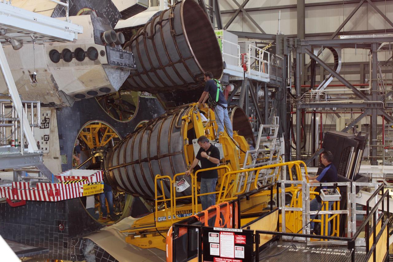 CAPE CANAVERAL, Fla. – Inside Orbiter Processing Facility-2 at NASA’s Kennedy Space Center in Florida, United Space Alliance technicians on a Hyster forklift guide replica shuttle main engine 2, or RSME 2, closer for installation on space shuttle Endeavour as USA technicians in the aft area monitor the progress. The orbiter is surrounded by work platforms allowing access to all areas of the spacecraft. The work is part of Transition and Retirement of the remaining space shuttles, Endeavour and Atlantis. Endeavour is being prepared for public display at the California Science Center in Los Angeles. Its ferry flight to California is targeted for mid-September. Endeavour was the last space shuttle added to NASA’s orbiter fleet. Over the course of its 19-year career, Endeavour spent 299 days in space during 25 missions. For more information, visit http://www.nasa.gov/shuttle. Photo credit: NASA/David Lee