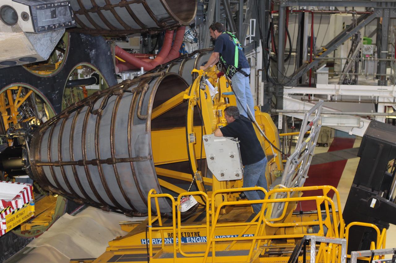 CAPE CANAVERAL, Fla. – Inside Orbiter Processing Facility-2 at NASA’s Kennedy Space Center in Florida, United Space Alliance technicians on a Hyster forklift guide replica shuttle main engine 2, or RSME 2, closer for installation on space shuttle Endeavour. The orbiter is surrounded by work platforms allowing access to all areas of the spacecraft. The work is part of Transition and Retirement of the remaining space shuttles, Endeavour and Atlantis. Endeavour is being prepared for public display at the California Science Center in Los Angeles. Its ferry flight to California is targeted for mid-September. Endeavour was the last space shuttle added to NASA’s orbiter fleet. Over the course of its 19-year career, Endeavour spent 299 days in space during 25 missions. For more information, visit http://www.nasa.gov/shuttle. Photo credit: NASA/David Lee