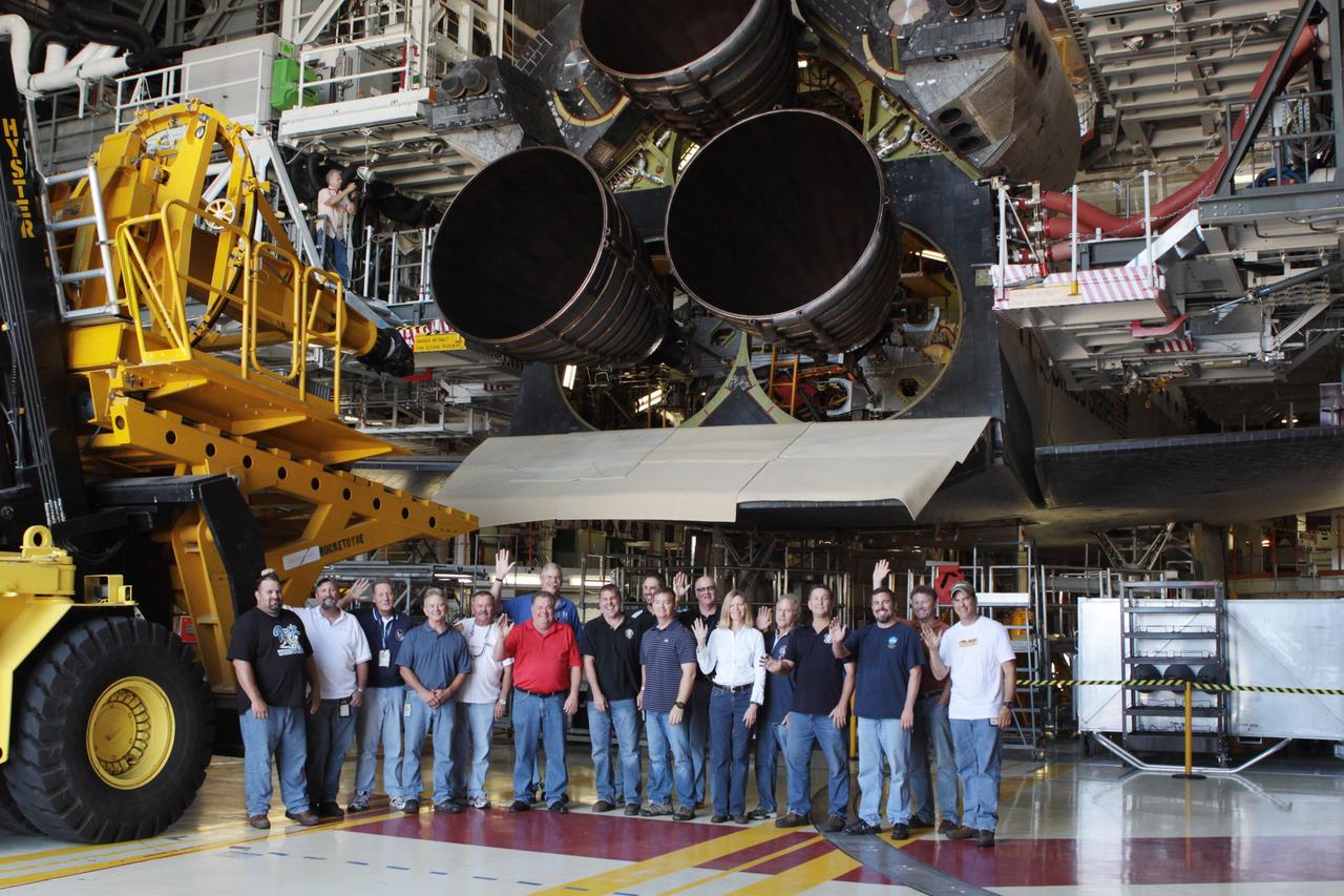 CAPE CANAVERAL, Fla. – Inside Orbiter Processing Facility-2 at NASA’s Kennedy Space Center in Florida, United Space Alliance technicians gather together after replica shuttle main engine 2, or RSME 2, was installed on space shuttle Endeavour. The orbiter is surrounded by work platforms allowing access to all areas of the spacecraft. The work is part of Transition and Retirement of the remaining space shuttles, Endeavour and Atlantis. Endeavour is being prepared for public display at the California Science Center in Los Angeles. Its ferry flight to California is targeted for mid-September. Endeavour was the last space shuttle added to NASA’s orbiter fleet. Over the course of its 19-year career, Endeavour spent 299 days in space during 25 missions. For more information, visit http://www.nasa.gov/shuttle. Photo credit: NASA/David Lee