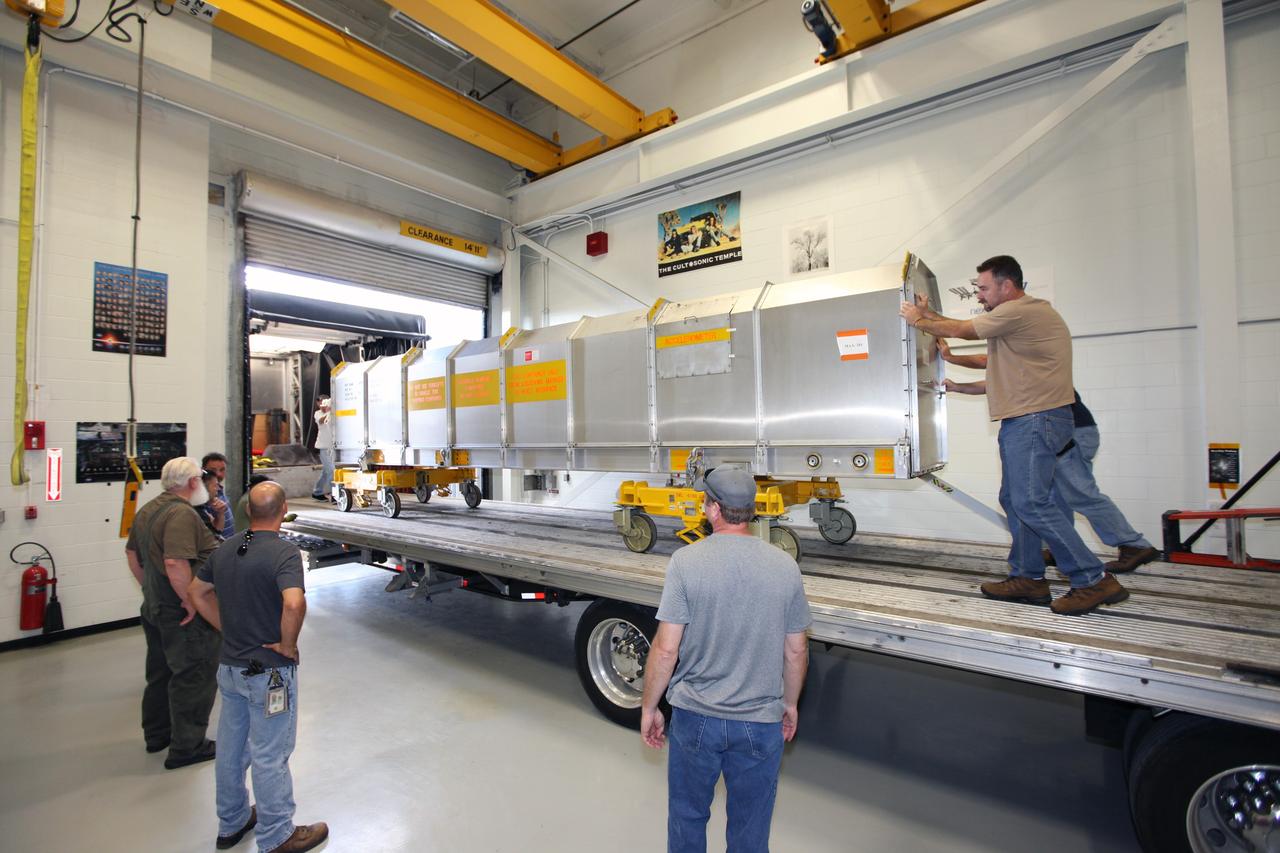 CAPE CANAVERAL, Fla. - Inside the Vehicle Assembly Building at NASA’s Kennedy Space Center in Florida, United Space Alliance workers position the container holding the remote manipulator system, or RMS, onto a flatbed truck for shipment back to the Canadian Space Agency. The RMS, also called the Canadarm, was manufactured for NASA’s Space Shuttle Program by SPAR Aerospace Ltd., which later became a part of MD Robotics in Ontario, Canada. During shuttle missions, the RMS was attached in the payload bay. Mission specialists operated the arm to remove payloads from the payload bay and hand them off to the larger Canadarm 2 on the International Space Station. The shuttle arm also was used during astronaut spacewalks. Photo credit: NASA/Kim Shiflett