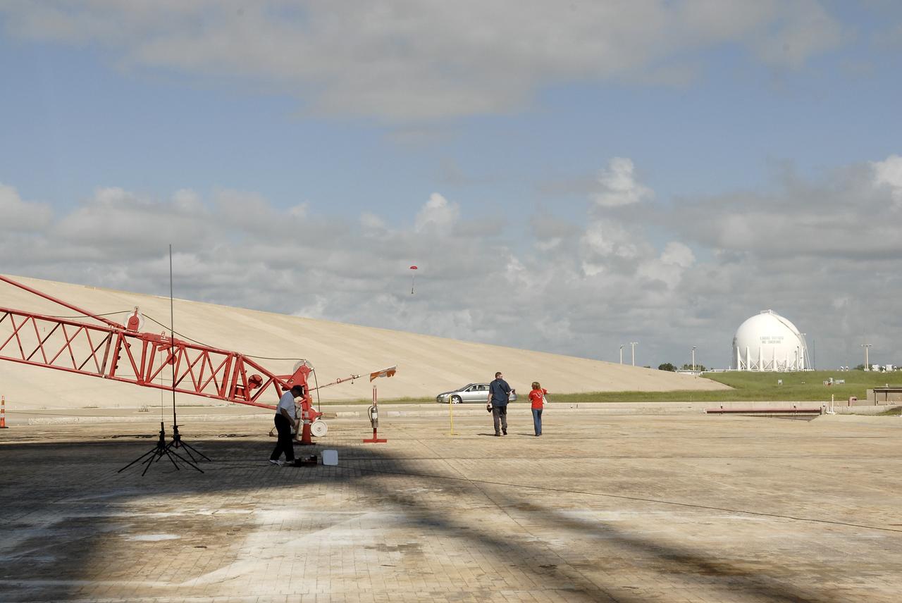 CAPE CANAVERAL, Fla. – A model rocket built by students of the International Space University parachutes back to Earth during the rocket launch competition of the ISU's summer session. The competition was conducted at Launch Complex 39A at NASA's Kennedy Space Center in Florida, which co-hosted this year's ISU. Six teams designed and built large model rockets, each between three and five feet tall, and launched them from Launch Pad 39A, the starting point for Apollo missions to the moon and dozens of space shuttle flights. Each launch carried a raw egg, dubbed "eggstronauts" and had to recover it intact to be declared successful. Photo credit: NASA/Charisse Nahsser