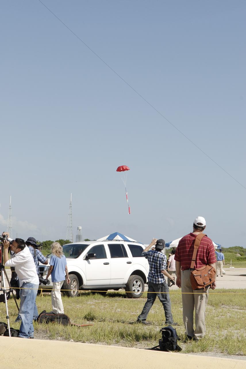 CAPE CANAVERAL, Fla. – A model rocket built by students of the International Space University parachutes back to Earth during the rocket launch competition of the ISU's summer session. The competition was conducted at Launch Complex 39A at NASA's Kennedy Space Center in Florida, which co-hosted this year's ISU. Six teams designed and built large model rockets, each between three and five feet tall, and launched them from Launch Pad 39A, the starting point for Apollo missions to the moon and dozens of space shuttle flights. Each launch carried a raw egg, dubbed "eggstronauts" and had to recover it intact to be declared successful. Photo credit: NASA/Charisse Nahsser