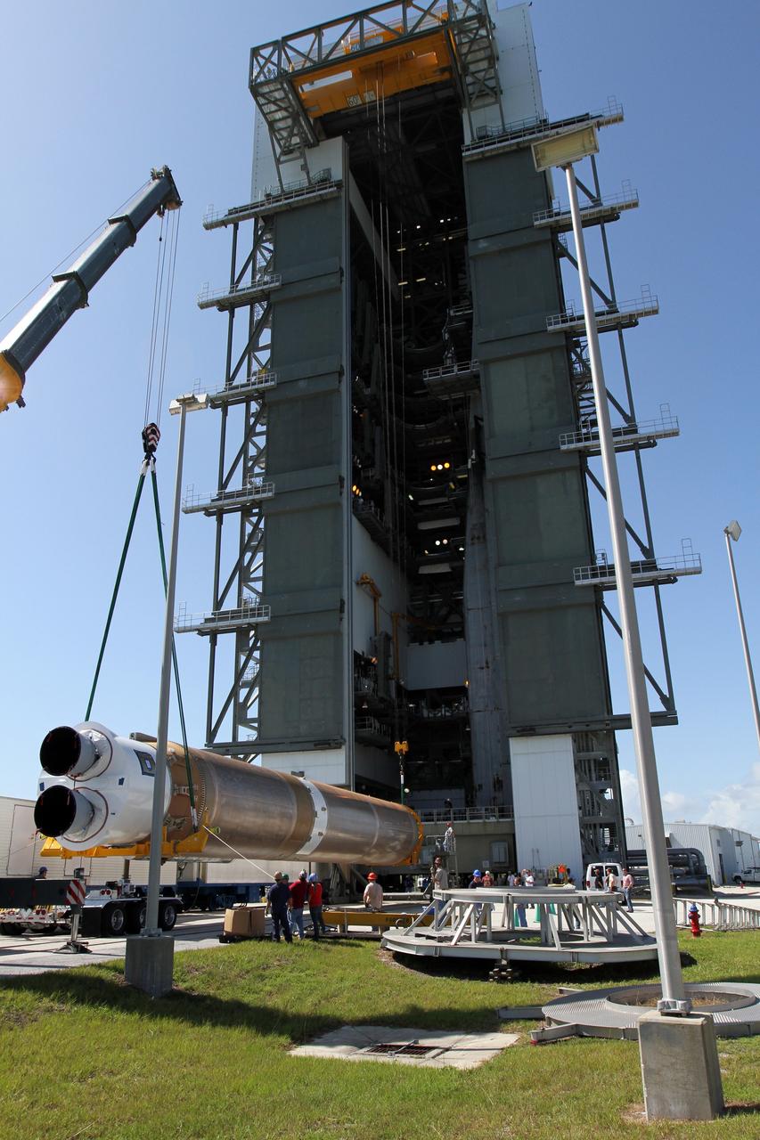 CAPE CANAVERAL, Fla. - At Launch Complex 41 at Cape Canaveral Air Force Station in Florida, technicians use a large crane to lift the first stage of the United Launch Alliance Atlas V rocket into the vertical position. The Atlas V is being prepared for the Radiation Belt Storm Probes, or RBSP, mission.    NASA’s RBSP mission will help us understand the sun’s influence on Earth and near-Earth space by studying the Earth’s radiation belts on various scales of space and time. RBSP will begin its mission of exploration of Earth’s Van Allen radiation belts and the extremes of space weather after its launch aboard an Atlas V rocket. Launch is targeted for Aug. 23. For more information, visit http://www.nasa.gov/rbsp. Photo credit: NASA/Cory Huston