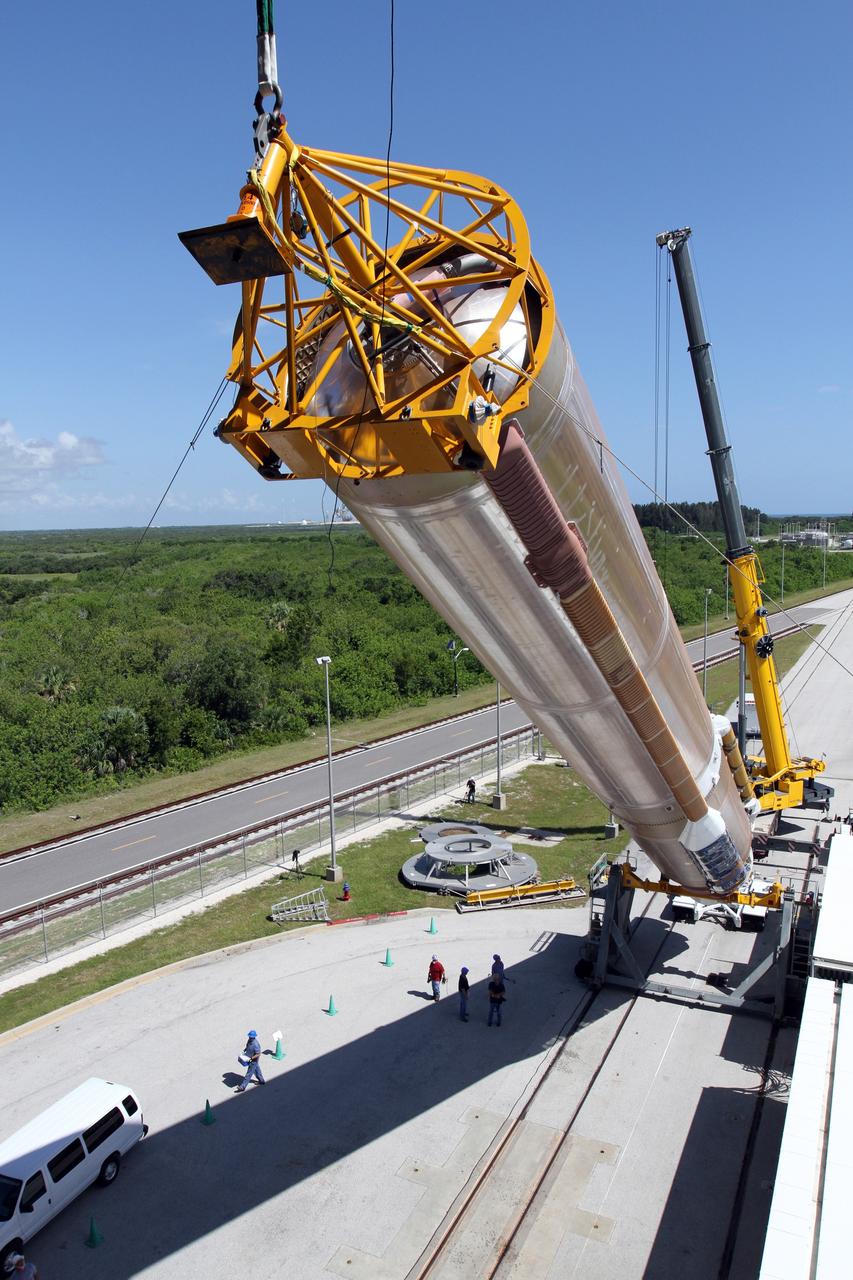 CAPE CANAVERAL, Fla. - At Launch Complex 41 at Cape Canaveral Air Force Station in Florida, a large crane lifts the first stage of the United Launch Alliance Atlas V rocket into the vertical position. The Atlas V is being prepared for the Radiation Belt Storm Probes, or RBSP, mission.    NASA’s RBSP mission will help us understand the sun’s influence on Earth and near-Earth space by studying the Earth’s radiation belts on various scales of space and time. RBSP will begin its mission of exploration of Earth’s Van Allen radiation belts and the extremes of space weather after its launch aboard an Atlas V rocket. Launch is targeted for Aug. 23. For more information, visit http://www.nasa.gov/rbsp. Photo credit: NASA/Cory Huston