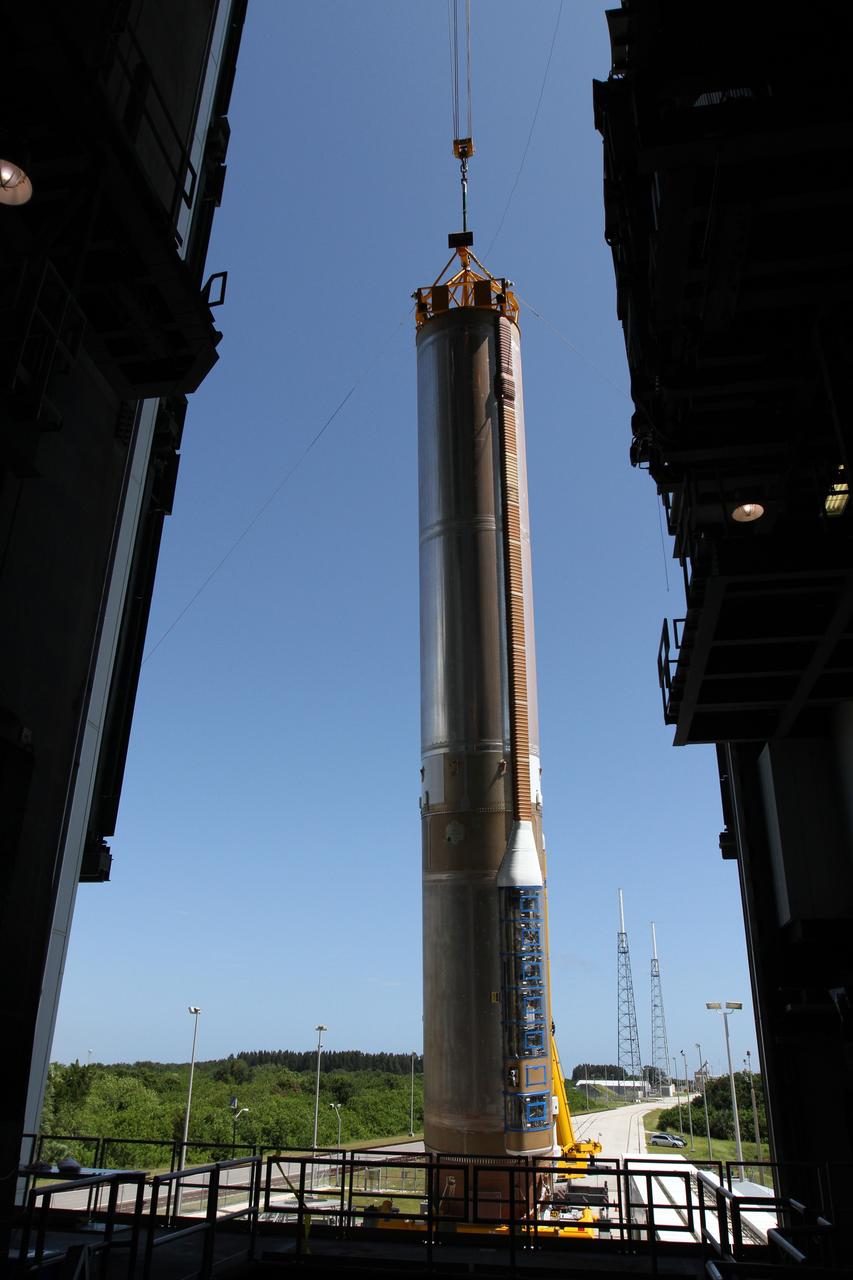 CAPE CANAVERAL, Fla. - At Launch Complex 41 at Cape Canaveral Air Force Station in Florida, a large crane lifts the first stage of the United Launch Alliance Atlas V rocket into the vertical position. The Atlas V is being prepared for the Radiation Belt Storm Probes, or RBSP, mission.    NASA’s RBSP mission will help us understand the sun’s influence on Earth and near-Earth space by studying the Earth’s radiation belts on various scales of space and time. RBSP will begin its mission of exploration of Earth’s Van Allen radiation belts and the extremes of space weather after its launch aboard an Atlas V rocket. Launch is targeted for Aug. 23. For more information, visit http://www.nasa.gov/rbsp. Photo credit: NASA/Cory Huston