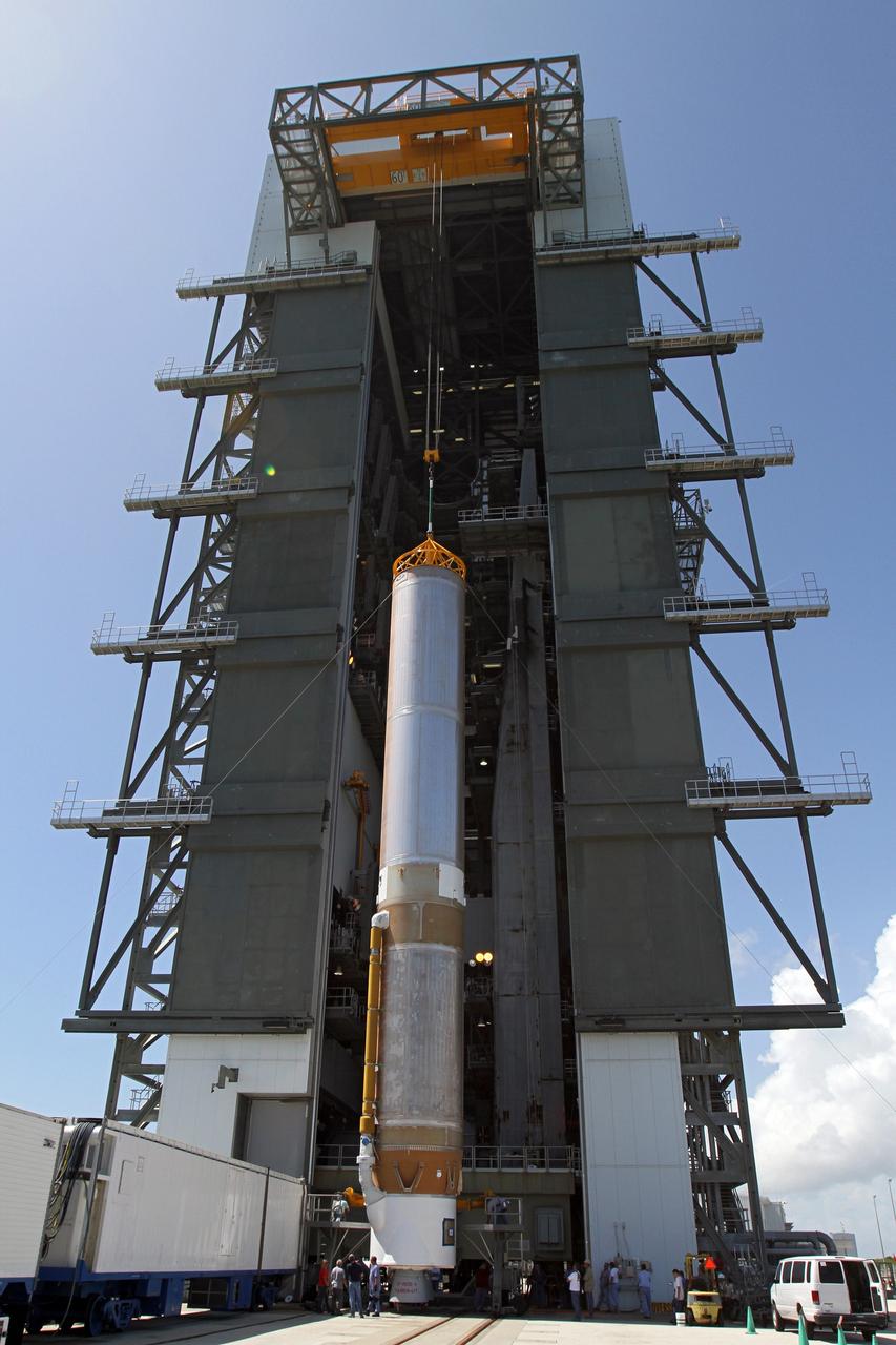 CAPE CANAVERAL, Fla. - At Launch Complex 41 at Cape Canaveral Air Force Station in Florida, a large crane lifts the first stage of the United Launch Alliance Atlas V rocket into the vertical position. The Atlas V is being prepared for the Radiation Belt Storm Probes, or RBSP, mission.    NASA’s RBSP mission will help us understand the sun’s influence on Earth and near-Earth space by studying the Earth’s radiation belts on various scales of space and time. RBSP will begin its mission of exploration of Earth’s Van Allen radiation belts and the extremes of space weather after its launch aboard an Atlas V rocket. Launch is targeted for Aug. 23. For more information, visit http://www.nasa.gov/rbsp. Photo credit: NASA/Cory Huston