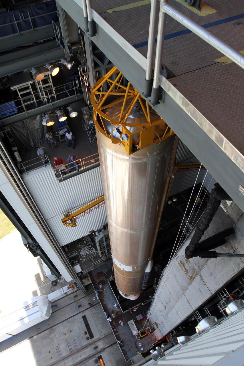 CAPE CANAVERAL, Fla. - At Launch Complex 41 at Cape Canaveral Air Force Station in Florida, a large crane moves the first stage of the United Launch Alliance Atlas V rocket into the Vertical Integration Facility. The Atlas V is being prepared for the Radiation Belt Storm Probes, or RBSP, mission.    NASA’s RBSP mission will help us understand the sun’s influence on Earth and near-Earth space by studying the Earth’s radiation belts on various scales of space and time. RBSP will begin its mission of exploration of Earth’s Van Allen radiation belts and the extremes of space weather after its launch aboard an Atlas V rocket. Launch is targeted for Aug. 23. For more information, visit http://www.nasa.gov/rbsp. Photo credit: NASA/Cory Huston