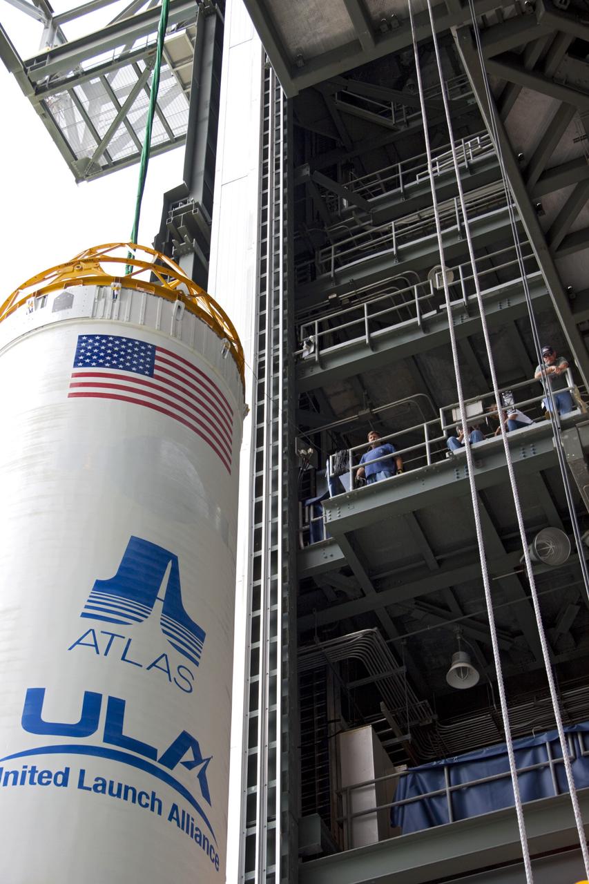CAPE CANAVERAL, Fla. – At Space Launch Complex 41 at Cape Canaveral Air Force Station, Fla., United Launch Alliance technicians keep watch as the Centaur stage is being lifted for mating with the Atlas V rocket, which will launch the Radiation Belt Storm Probes, or RBSP, spacecraft. NASA’s RBSP mission will help us understand the sun’s influence on Earth and near-Earth space by studying the Earth’s radiation belts on various scales of space and time. RBSP will begin its mission of exploration of Earth’s Van Allen radiation belts and the extremes of space weather after its liftoff aboard a United Launch Alliance Atlas V from Cape Canaveral. Liftoff is targeted for Aug. 23, 2012. For more information, visit http://www.nasa.gov/rbsp. Photo credit: NASA/Jim Grossmann