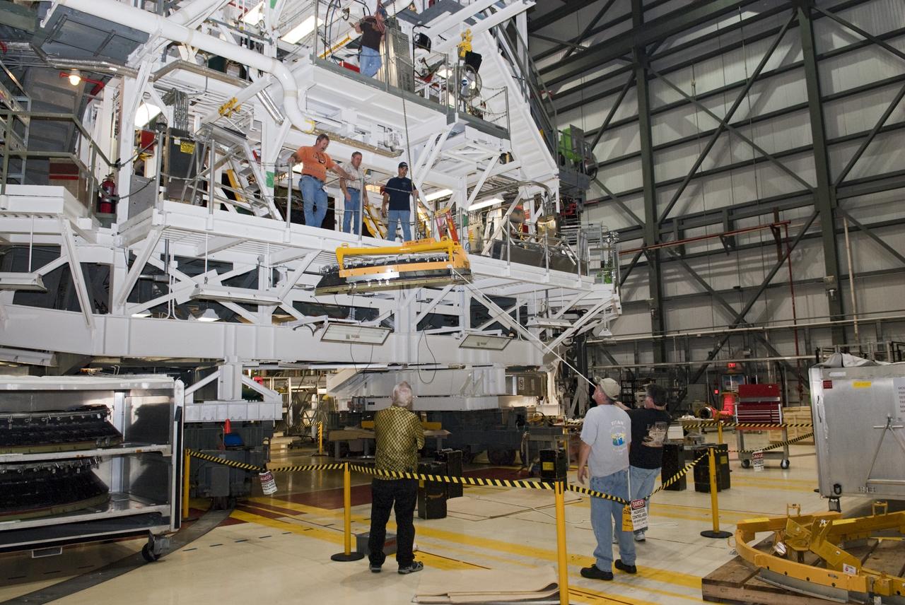 CAPE CANAVERAL, Fla. – In Orbiter Processing Facility Bay 2 at NASA’s Kennedy Space Center in Florida, United Space Alliance technicians lift a heat shield for installation around space shuttle Endeavour’s replica shuttle main engine RSME number 1.      The work is part of Transition and Retirement of the remaining space shuttles, Endeavour and Atlantis. Endeavour is being prepared for public display at the California Science Center in Los Angeles. Its ferry flight to California is targeted for mid-September. Endeavour was the last space shuttle added to NASA’s orbiter fleet. Over the course of its 19-year career, Endeavour spent 299 days in space during 25 missions. For more information, visit http://www.nasa.gov/transition Photo credit: NASA/ Tim Jacobs