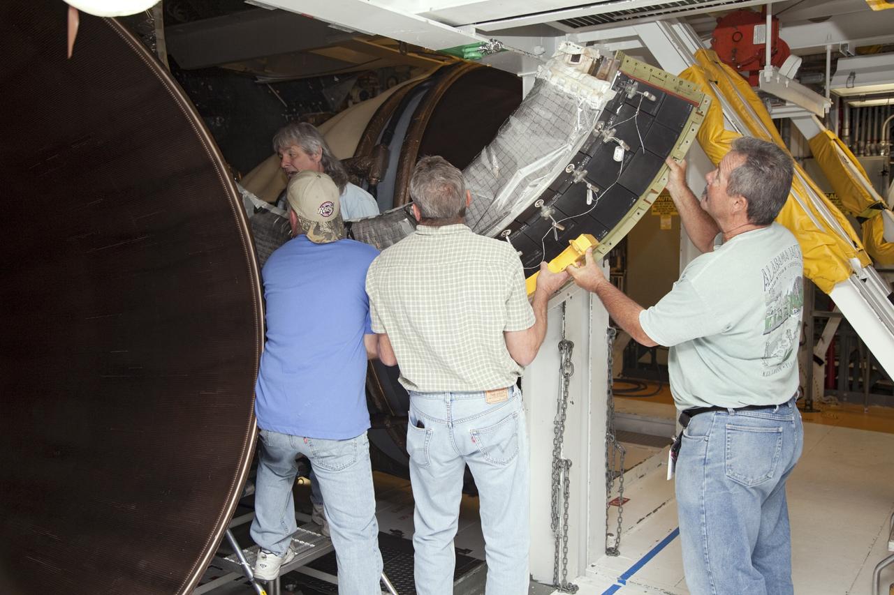CAPE CANAVERAL, Fla. – In Orbiter Processing Facility Bay 2 at NASA’s Kennedy Space Center in Florida, United Space Alliance technicians move a heat shield for installation around one of space shuttle Endeavour’s replica shuttle main engines.      The work is part of Transition and Retirement of the remaining space shuttles, Endeavour and Atlantis. Endeavour is being prepared for public display at the California Science Center in Los Angeles. Its ferry flight to California is targeted for mid-September. Endeavour was the last space shuttle added to NASA’s orbiter fleet. Over the course of its 19-year career, Endeavour spent 299 days in space during 25 missions. For more information, visit http://www.nasa.gov/transition Photo credit: NASA/ Frankie Martin