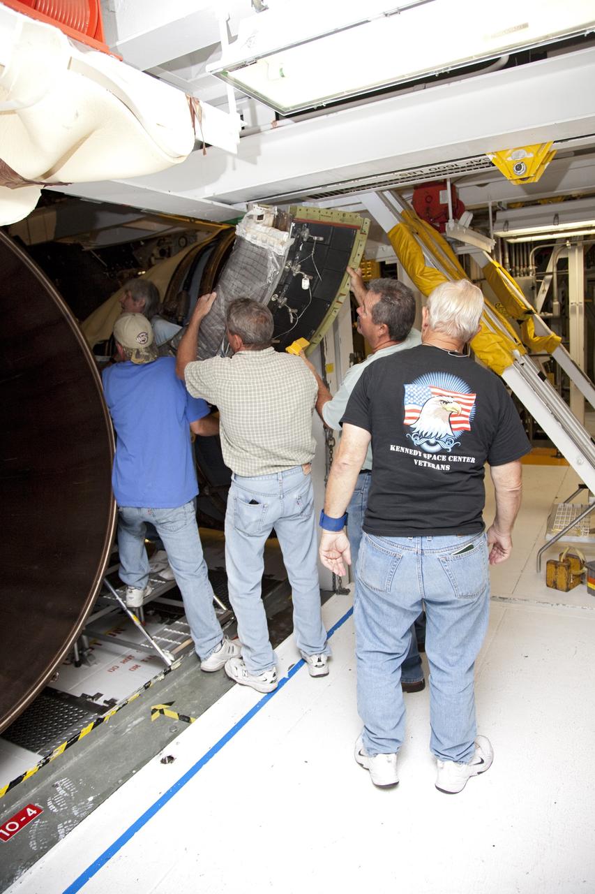 CAPE CANAVERAL, Fla. – In Orbiter Processing Facility Bay 2 at NASA’s Kennedy Space Center in Florida, United Space Alliance technicians move a heat shield for installation around one of space shuttle Endeavour’s replica shuttle main engines.      The work is part of Transition and Retirement of the remaining space shuttles, Endeavour and Atlantis. Endeavour is being prepared for public display at the California Science Center in Los Angeles. Its ferry flight to California is targeted for mid-September. Endeavour was the last space shuttle added to NASA’s orbiter fleet. Over the course of its 19-year career, Endeavour spent 299 days in space during 25 missions. For more information, visit http://www.nasa.gov/transition Photo credit: NASA/ Frankie Martin