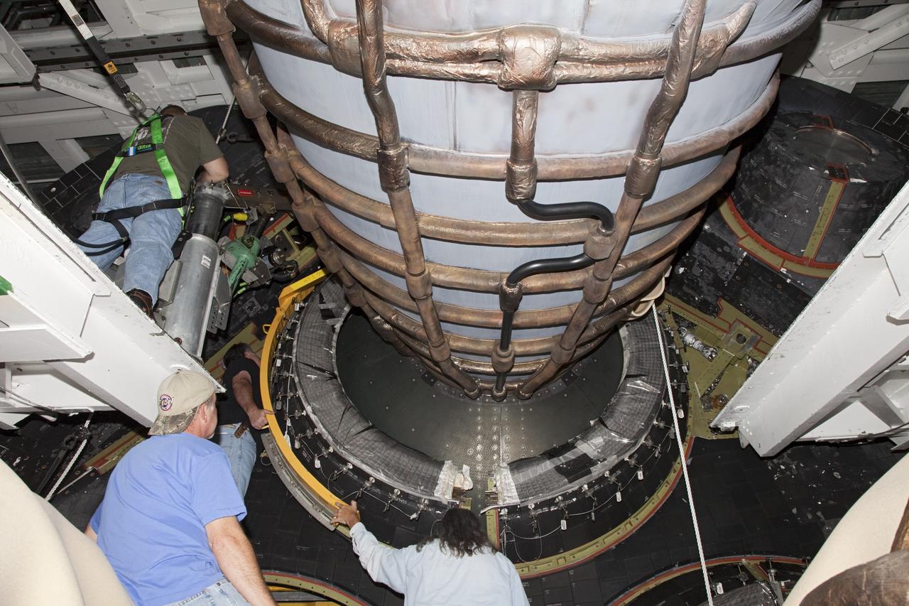 CAPE CANAVERAL, Fla. – In Orbiter Processing Facility Bay 2 at NASA’s Kennedy Space Center in Florida, United Space Alliance technicians install a heat shield around one of space shuttle Endeavour’s replica shuttle main engines.      The work is part of Transition and Retirement of the remaining space shuttles, Endeavour and Atlantis. Endeavour is being prepared for public display at the California Science Center in Los Angeles. Its ferry flight to California is targeted for mid-September. Endeavour was the last space shuttle added to NASA’s orbiter fleet. Over the course of its 19-year career, Endeavour spent 299 days in space during 25 missions. For more information, visit http://www.nasa.gov/transition Photo credit: NASA/ Frankie Martin