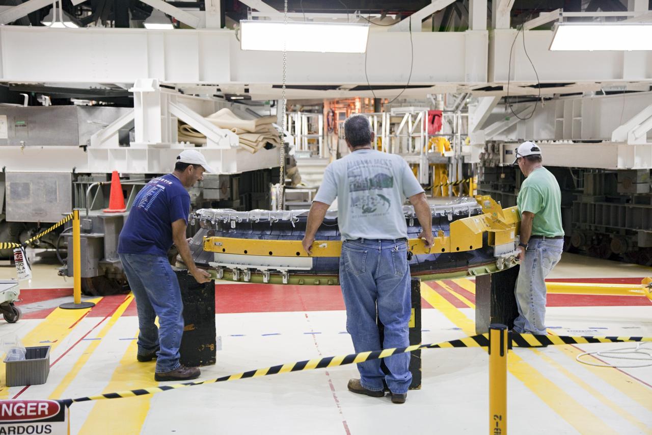 CAPE CANAVERAL, Fla. – In Orbiter Processing Facility Bay 2 at NASA’s Kennedy Space Center in Florida, United Space Alliance technicians prepare a heat shield for installation around space shuttle Endeavour’s replica shuttle main engines.      The work is part of Transition and Retirement of the remaining space shuttles, Endeavour and Atlantis. Endeavour is being prepared for public display at the California Science Center in Los Angeles. Its ferry flight to California is targeted for mid-September. Endeavour was the last space shuttle added to NASA’s orbiter fleet. Over the course of its 19-year career, Endeavour spent 299 days in space during 25 missions. For more information, visit http://www.nasa.gov/transition Photo credit: NASA/ Frankie Martin