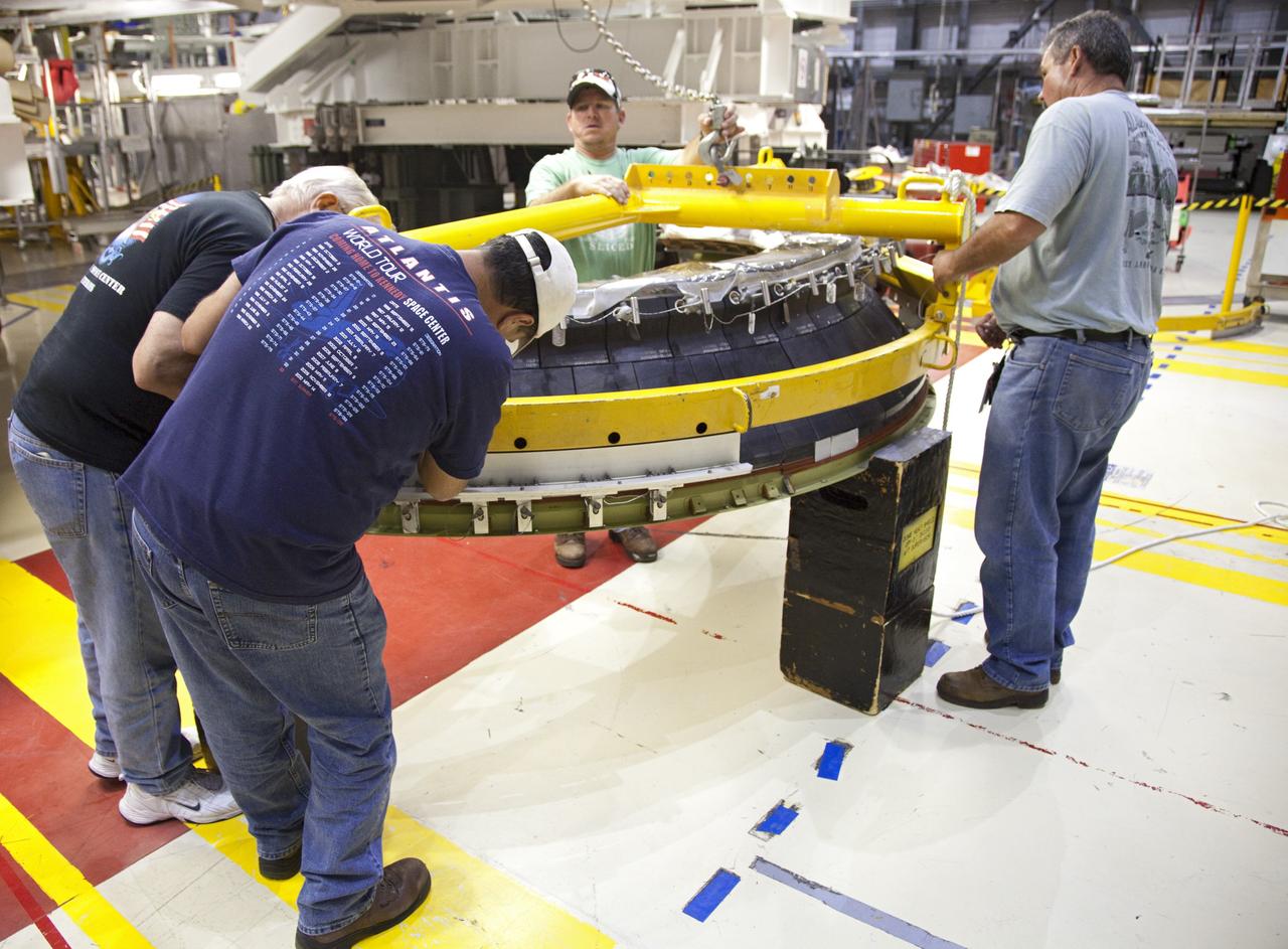 CAPE CANAVERAL, Fla. – In Orbiter Processing Facility Bay 2 at NASA’s Kennedy Space Center in Florida, United Space Alliance technicians prepare a heat shield for installation around space shuttle Endeavour’s replica shuttle main engines.      The work is part of Transition and Retirement of the remaining space shuttles, Endeavour and Atlantis. Endeavour is being prepared for public display at the California Science Center in Los Angeles. Its ferry flight to California is targeted for mid-September. Endeavour was the last space shuttle added to NASA’s orbiter fleet. Over the course of its 19-year career, Endeavour spent 299 days in space during 25 missions. For more information, visit http://www.nasa.gov/transition Photo credit: NASA/ Frankie Martin