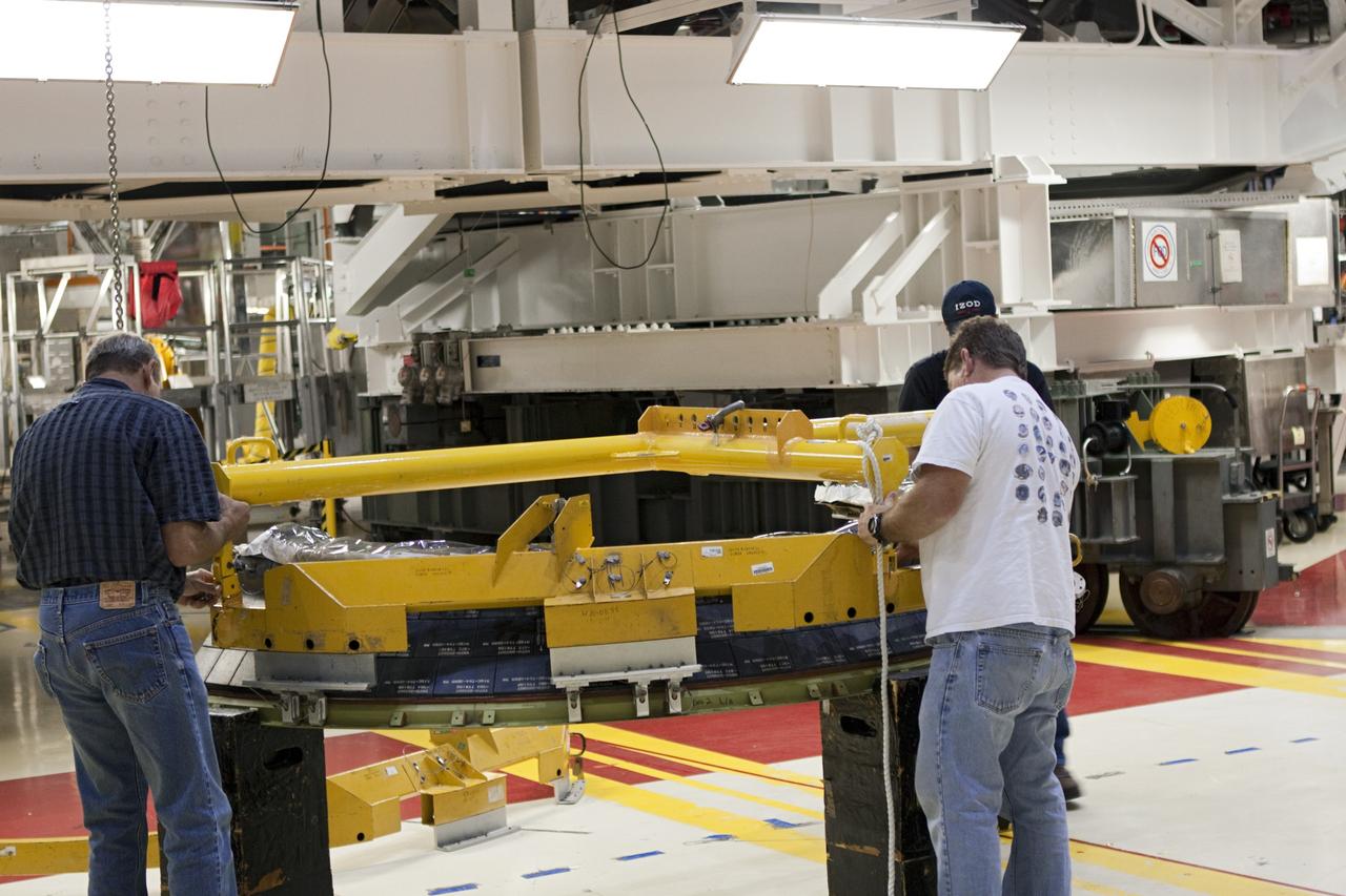 CAPE CANAVERAL, Fla. – In Orbiter Processing Facility Bay 2 at NASA’s Kennedy Space Center in Florida, United Space Alliance technicians prepare a heat shield for installation around space shuttle Endeavour’s replica shuttle main engines.      The work is part of Transition and Retirement of the remaining space shuttles, Endeavour and Atlantis. Endeavour is being prepared for public display at the California Science Center in Los Angeles. Its ferry flight to California is targeted for mid-September. Endeavour was the last space shuttle added to NASA’s orbiter fleet. Over the course of its 19-year career, Endeavour spent 299 days in space during 25 missions. For more information, visit http://www.nasa.gov/transition Photo credit: NASA/ Jim Grossmann
