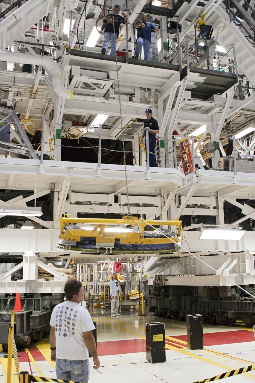 CAPE CANAVERAL, Fla. – In Orbiter Processing Facility Bay 2 at NASA’s Kennedy Space Center in Florida, United Space Alliance technicians lift a heat shield on to one of the work platforms for installation around one of space shuttle Endeavour’s replica shuttle main engines.      The work is part of Transition and Retirement of the remaining space shuttles, Endeavour and Atlantis. Endeavour is being prepared for public display at the California Science Center in Los Angeles. Its ferry flight to California is targeted for mid-September. Endeavour was the last space shuttle added to NASA’s orbiter fleet. Over the course of its 19-year career, Endeavour spent 299 days in space during 25 missions. For more information, visit http://www.nasa.gov/transition Photo credit: NASA/ Jim Grossmann