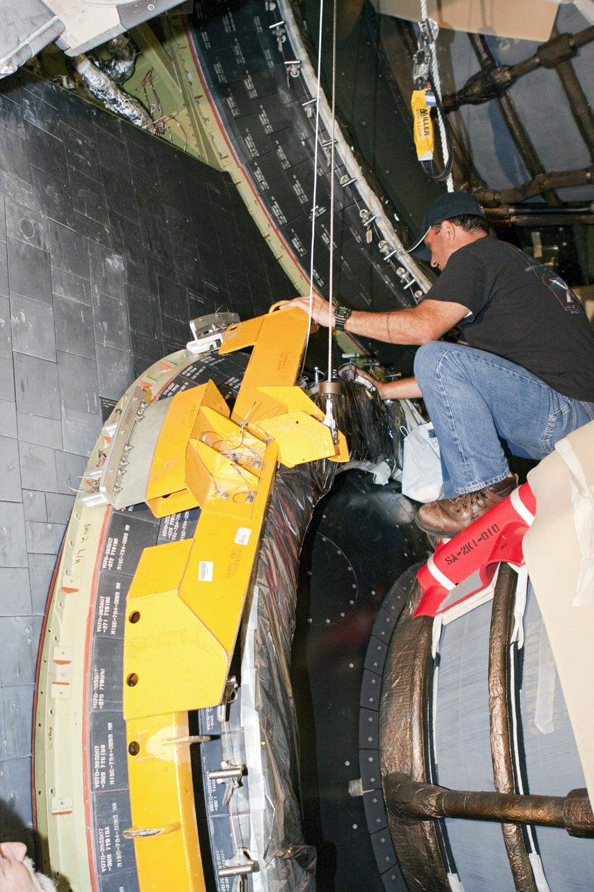 CAPE CANAVERAL, Fla. – In Orbiter Processing Facility Bay 2 at NASA’s Kennedy Space Center in Florida, United Space Alliance technicians install a heat shield around one of space shuttle Endeavour’s replica shuttle main engines.      The work is part of Transition and Retirement of the remaining space shuttles, Endeavour and Atlantis. Endeavour is being prepared for public display at the California Science Center in Los Angeles. Its ferry flight to California is targeted for mid-September. Endeavour was the last space shuttle added to NASA’s orbiter fleet. Over the course of its 19-year career, Endeavour spent 299 days in space during 25 missions. For more information, visit http://www.nasa.gov/transition Photo credit: NASA/ Jim Grossmann