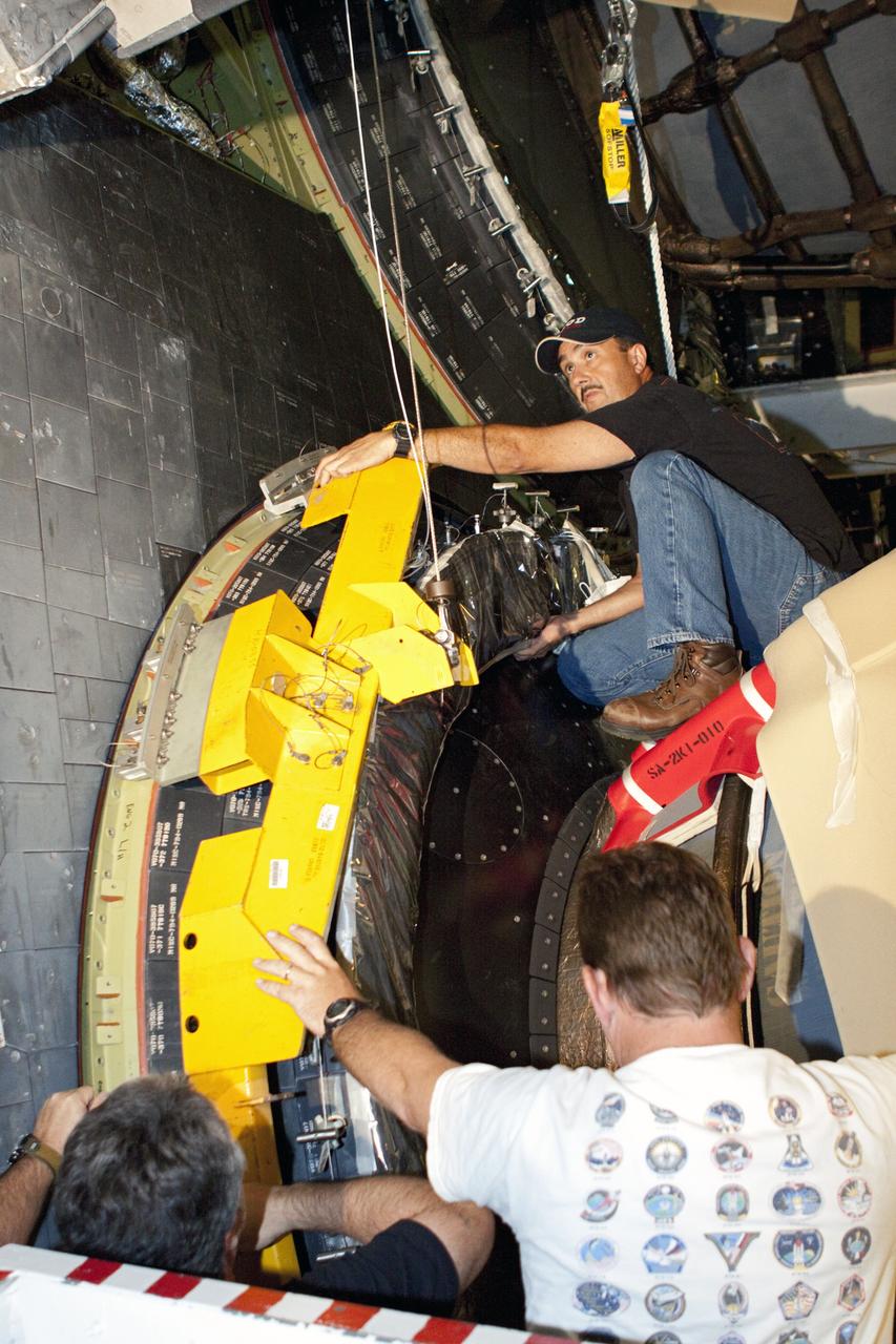 CAPE CANAVERAL, Fla. – In Orbiter Processing Facility Bay 2 at NASA’s Kennedy Space Center in Florida, United Space Alliance technicians install a heat shield around one of space shuttle Endeavour’s replica shuttle main engines.      The work is part of Transition and Retirement of the remaining space shuttles, Endeavour and Atlantis. Endeavour is being prepared for public display at the California Science Center in Los Angeles. Its ferry flight to California is targeted for mid-September. Endeavour was the last space shuttle added to NASA’s orbiter fleet. Over the course of its 19-year career, Endeavour spent 299 days in space during 25 missions. For more information, visit http://www.nasa.gov/transition Photo credit: NASA/ Jim Grossmann