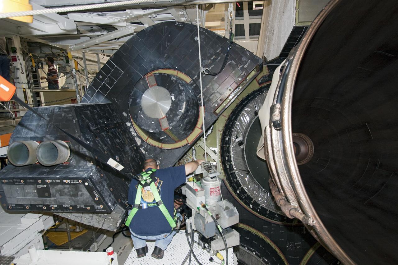 CAPE CANAVERAL, Fla. – In Orbiter Processing Facility Bay 2 at NASA’s Kennedy Space Center in Florida, United Space Alliance technicians install a heat shield around one of space shuttle Endeavour’s replica shuttle main engines.      The work is part of Transition and Retirement of the remaining space shuttles, Endeavour and Atlantis. Endeavour is being prepared for public display at the California Science Center in Los Angeles. Its ferry flight to California is targeted for mid-September. Endeavour was the last space shuttle added to NASA’s orbiter fleet. Over the course of its 19-year career, Endeavour spent 299 days in space during 25 missions. For more information, visit http://www.nasa.gov/transition Photo credit: NASA/ Jim Grossmann