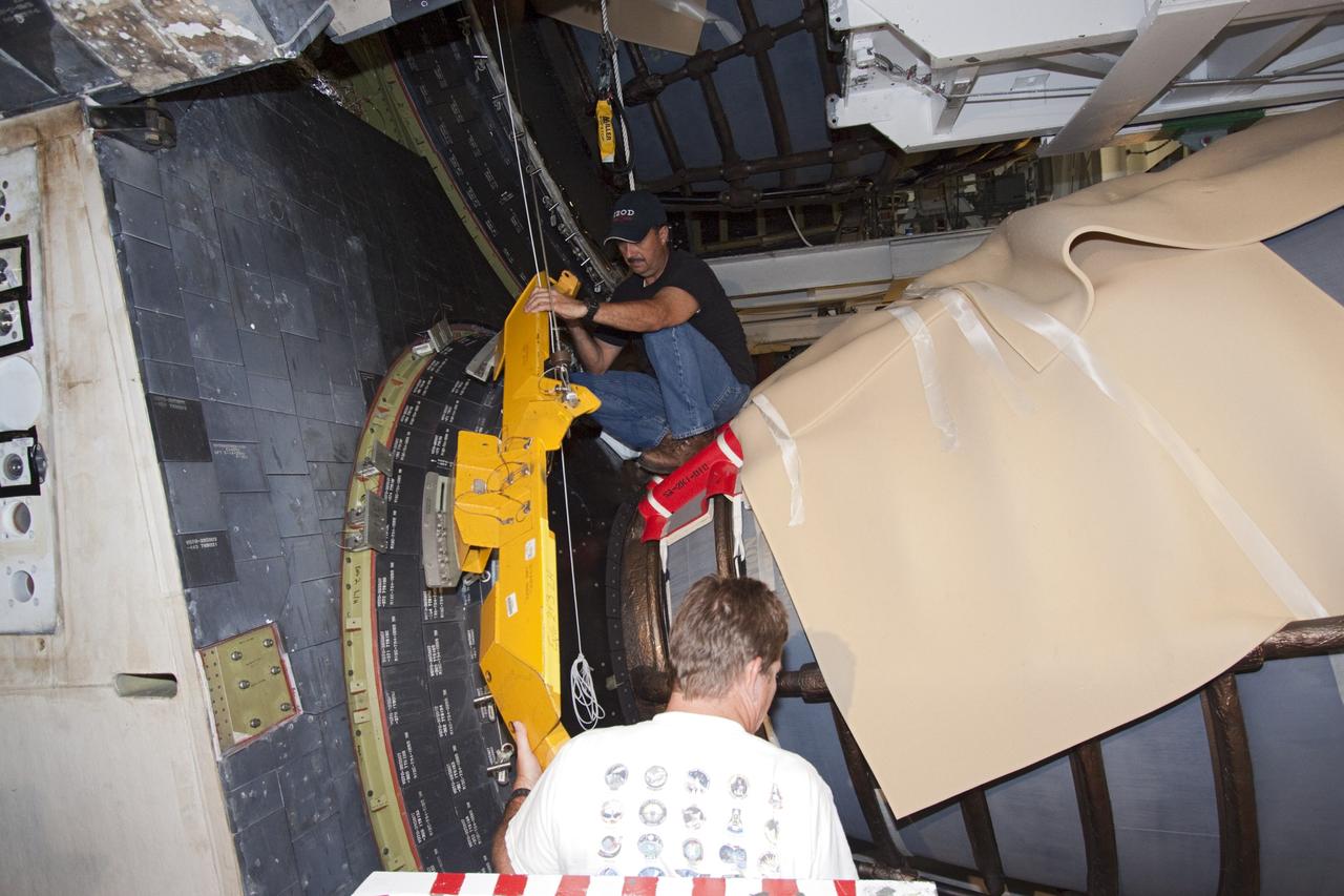 CAPE CANAVERAL, Fla. – In Orbiter Processing Facility Bay 2 at NASA’s Kennedy Space Center in Florida, United Space Alliance technicians install a heat shield around one of space shuttle Endeavour’s replica shuttle main engines.      The work is part of Transition and Retirement of the remaining space shuttles, Endeavour and Atlantis. Endeavour is being prepared for public display at the California Science Center in Los Angeles. Its ferry flight to California is targeted for mid-September. Endeavour was the last space shuttle added to NASA’s orbiter fleet. Over the course of its 19-year career, Endeavour spent 299 days in space during 25 missions. For more information, visit http://www.nasa.gov/transition Photo credit: NASA/ Jim Grossmann