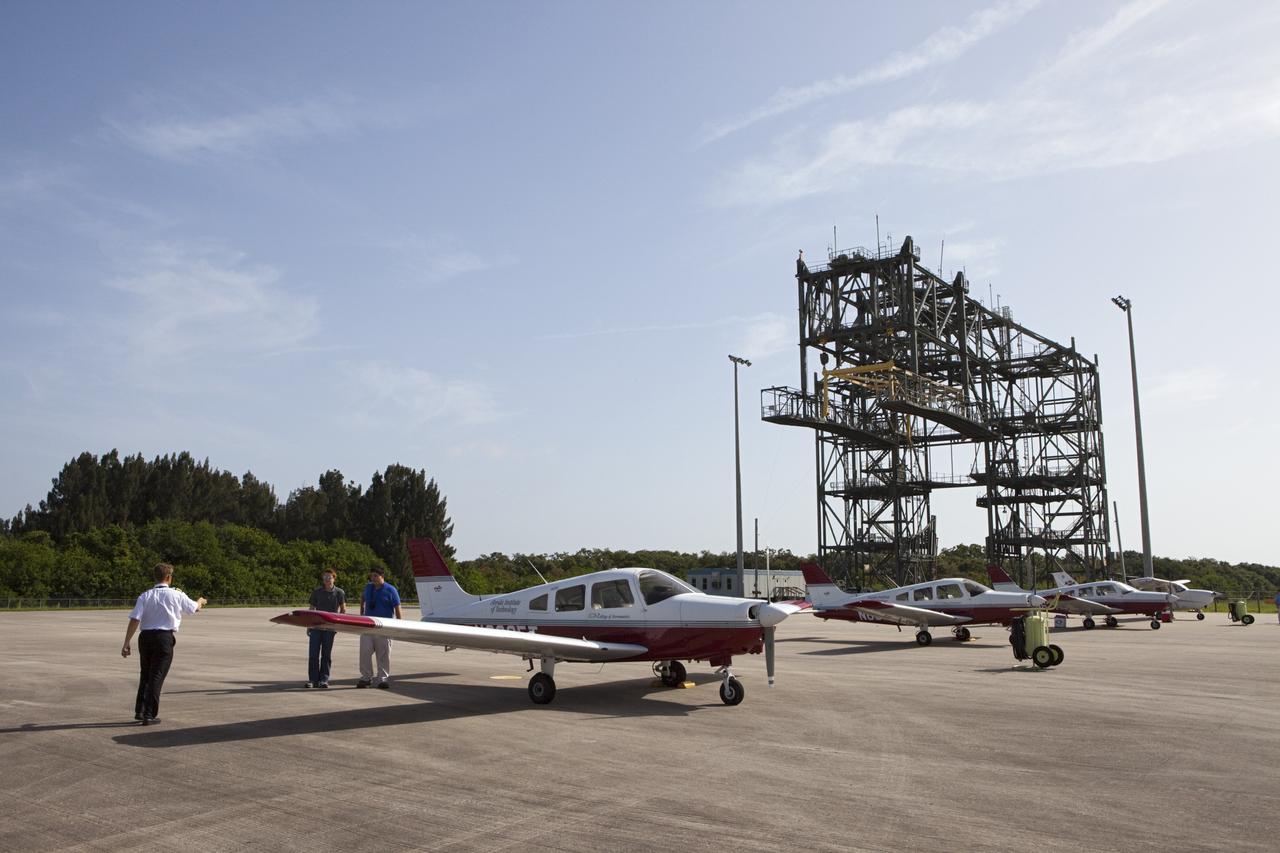 CAPE CANAVERAL, Fla. – Students and their flight instructors arrive at NASA Kennedy Space Center’s Shuttle Landing Facility, or SLF, in Florida in Cherokee Warrior and Cessna 172S lightweight aircraft from Florida Tech, or FIT, in Melbourne.    The middle and high school students are participating in FIT’s Av/Aero summer camp experience. They and their flight instructors toured the SLF midfield control tower, viewed F104 Starfighters and NASA Huey helicopters in the RLV Hangar, viewed the runway plaques marking wheels stop for each of the three space shuttles, and toured the Vehicle Assembly Building where space shuttle Atlantis currently is stored. Photo credit: NASA/Kim Shiflett