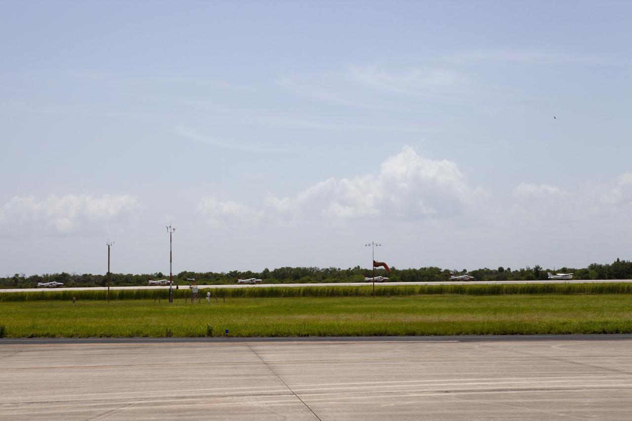 CAPE CANAVERAL, Fla. – At NASA Kennedy Space Center in Florida, flight instructors and their students from Florida Tech, or FIT, in Melbourne prepare to depart the Shuttle Landing Facility, or SLF, in Cherokee Warrior and Cessna 172S lightweight aircraft.    The middle and high school students are participating in FIT’s Av/Aero summer camp experience. They and their flight instructors toured the SLF midfield control tower, viewed F104 Starfighters and NASA Huey helicopters in the RLV Hangar, viewed the runway plaques marking wheels stop for each of the three space shuttles, and toured the Vehicle Assembly Building where space shuttle Atlantis currently is stored. Photo credit: NASA/Kim Shiflett