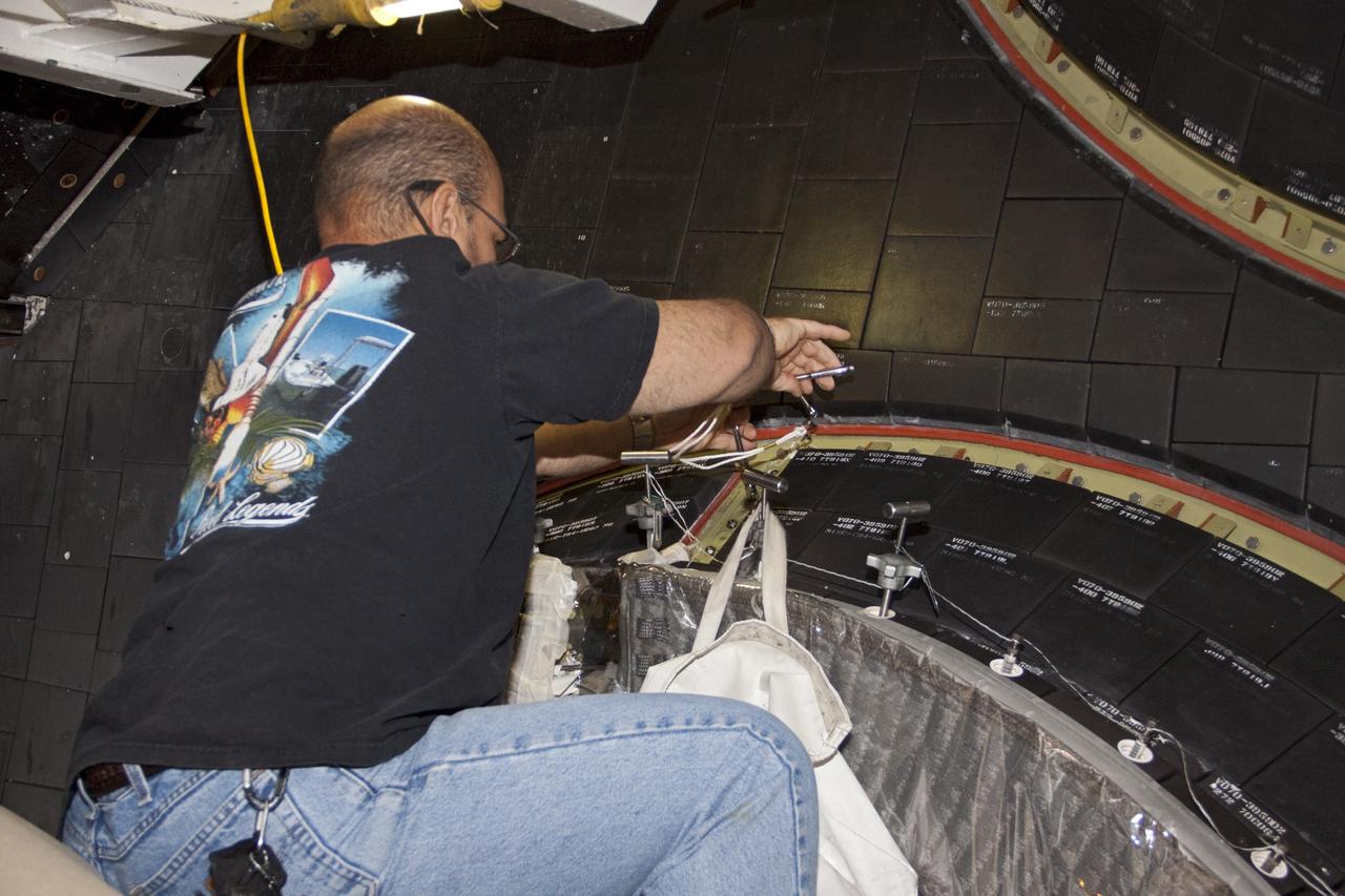 CAPE CANAVERAL, Fla. – In Orbiter Processing Facility Bay 2 at NASA’s Kennedy Space Center in Florida, a United Space Alliance technician installs a heat shield carrier panel on the space shuttle Endeavour.      The work is part of Transition and Retirement of the remaining space shuttles, Endeavour and Atlantis. Endeavour is being prepared for public display at the California Science Center in Los Angeles. Its ferry flight to California is targeted for mid-September. Endeavour was the last space shuttle added to NASA’s orbiter fleet. Over the course of its 19-year career, Endeavour spent 299 days in space during 25 missions. For more information, visit http://www.nasa.gov/transition Photo credit: NASA/ Jim Grossmann
