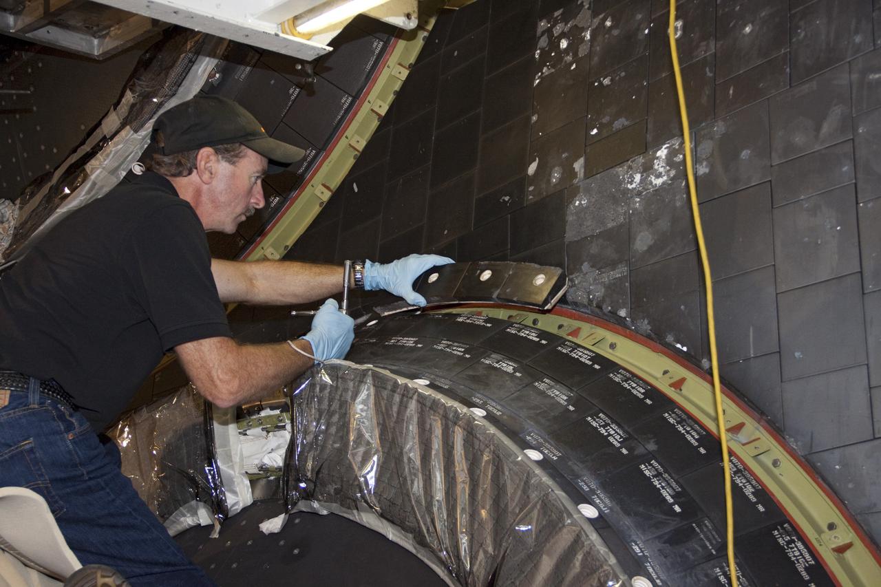 CAPE CANAVERAL, Fla. – In Orbiter Processing Facility Bay 2 at NASA’s Kennedy Space Center in Florida, United Space Alliance aerospace technician Chris Peluso installs a heat shield carrier panel on the space shuttle Endeavour.      The work is part of Transition and Retirement of the remaining space shuttles, Endeavour and Atlantis. Endeavour is being prepared for public display at the California Science Center in Los Angeles. Its ferry flight to California is targeted for mid-September. Endeavour was the last space shuttle added to NASA’s orbiter fleet. Over the course of its 19-year career, Endeavour spent 299 days in space during 25 missions. For more information, visit http://www.nasa.gov/transition Photo credit: NASA/ Jim Grossmann