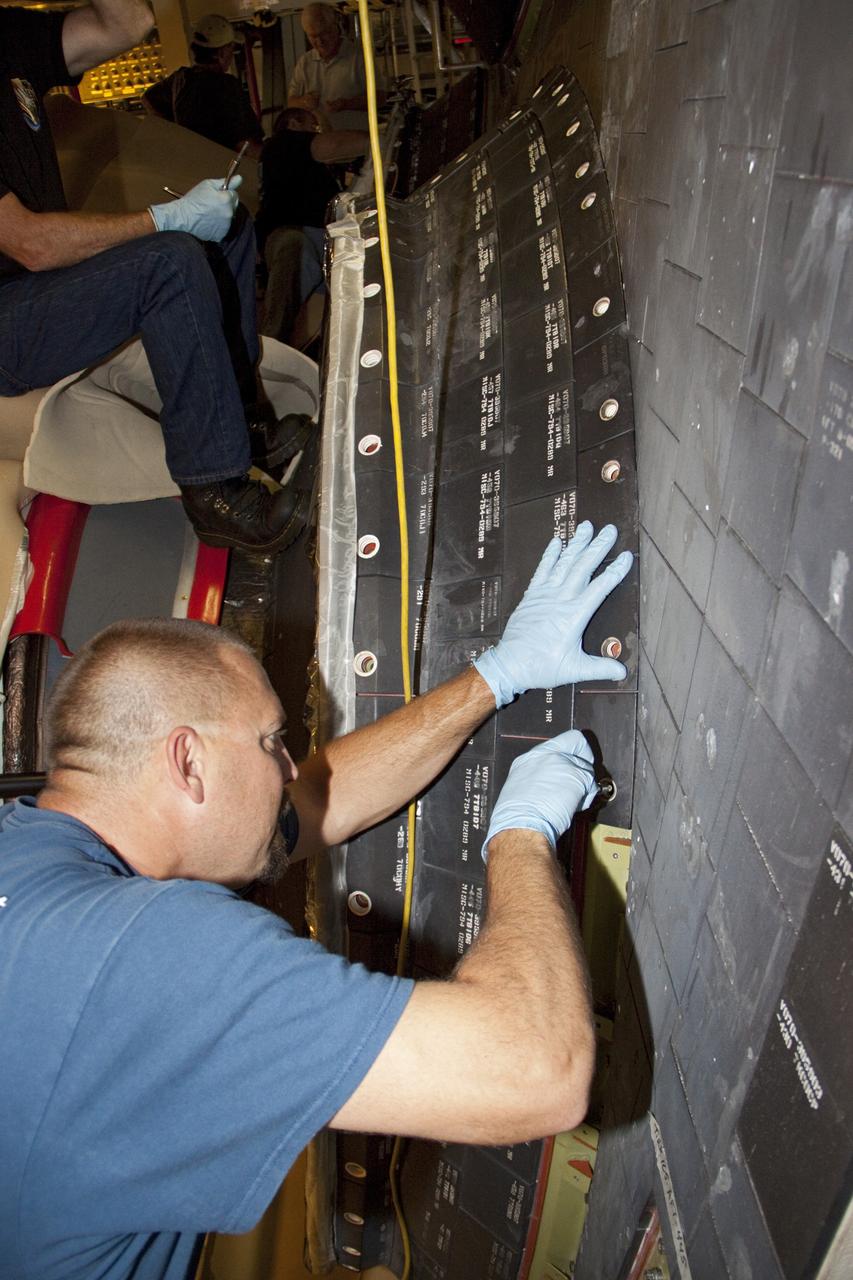 CAPE CANAVERAL, Fla. – In Orbiter Processing Facility Bay 2 at NASA’s Kennedy Space Center in Florida, United Space Alliance aerospace technician Tom Goldean installs a heat shield carrier panel on the space shuttle Endeavour.      The work is part of Transition and Retirement of the remaining space shuttles, Endeavour and Atlantis. Endeavour is being prepared for public display at the California Science Center in Los Angeles. Its ferry flight to California is targeted for mid-September. Endeavour was the last space shuttle added to NASA’s orbiter fleet. Over the course of its 19-year career, Endeavour spent 299 days in space during 25 missions. For more information, visit http://www.nasa.gov/transition Photo credit: NASA/ Jim Grossmann