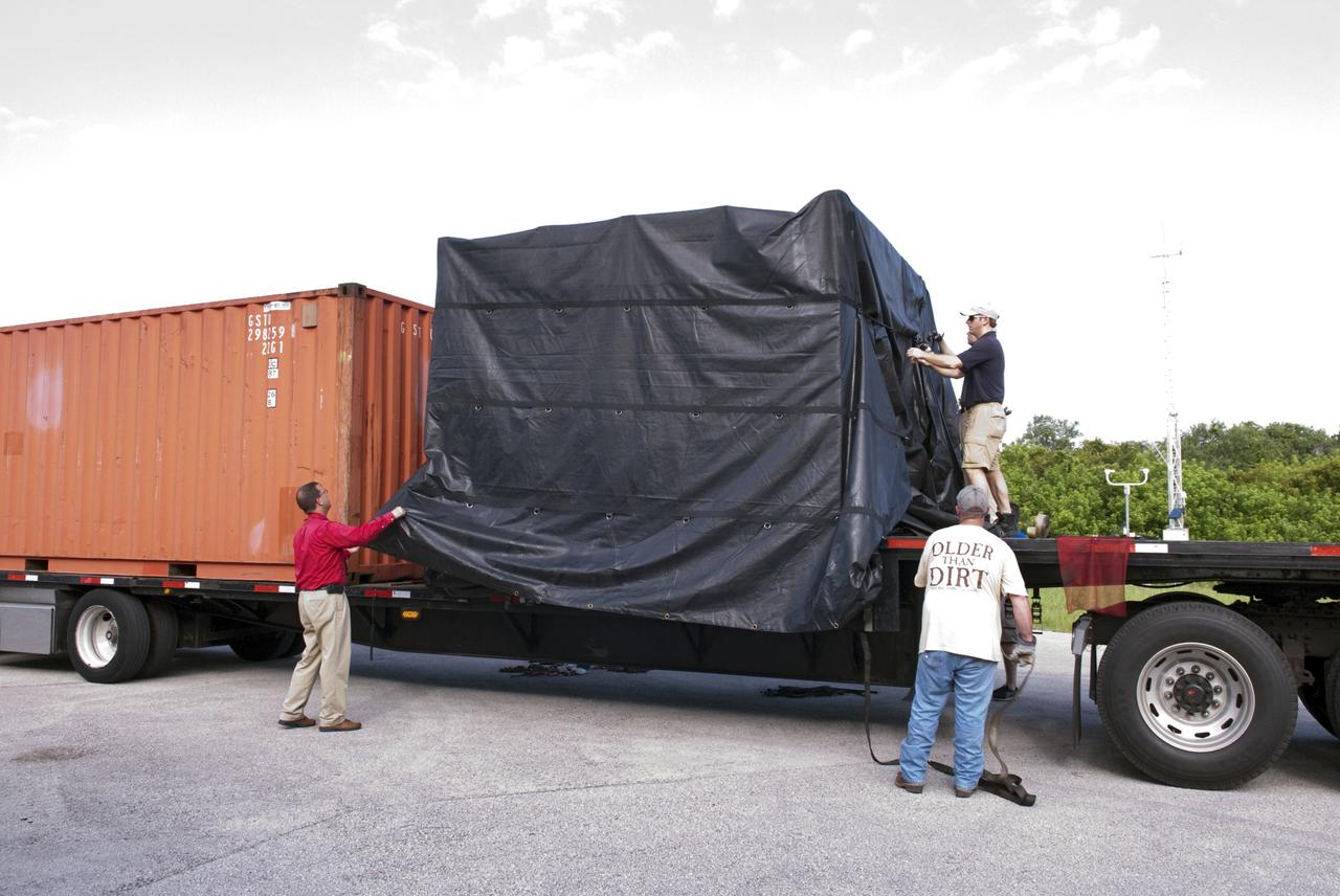 CAPE CANAVERAL, Fla. - NASA's Morpheus lander, a vertical test bed vehicle, is unloaded at a building at the Shuttle Landing Facility, or SLF, at the Kennedy Space Center in Florida. Morpheus is designed to demonstrate new green propellant propulsion systems and autonomous landing and an Autonomous Landing and Hazard Avoidance Technology, or ALHAT, system.      Checkout of the prototype lander has been ongoing at NASA’s Johnson Space Center in Houston in preparation for its first free flight. The SLF site will provide the lander with the kind of field necessary for realistic testing. Project Morpheus is one of 20 small projects comprising the Advanced Exploration Systems, or AES, program in NASA’s Human Exploration and Operations Mission Directorate. AES projects pioneer new approaches for rapidly developing prototype systems, demonstrating key capabilities and validating operational concepts for future human missions beyond Earth orbit. For more information on Project Morpheus, visit http://www.nasa.gov/centers/johnson/exploration/morpheus/index.html  Photo credit: NASA/ Charisse Nahser