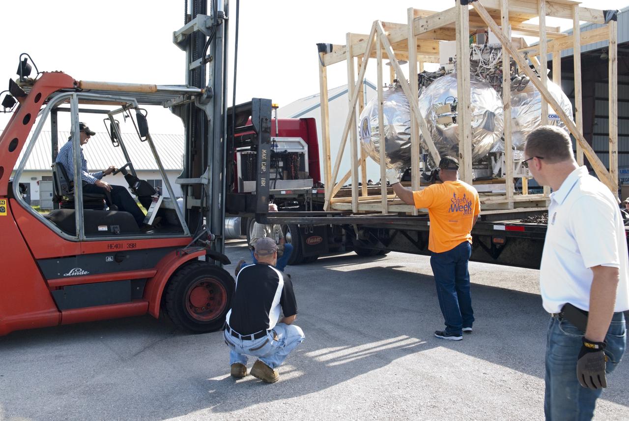 CAPE CANAVERAL, Fla. - NASA's Morpheus lander, a vertical test bed vehicle, is unloaded at a building at the Shuttle Landing Facility, or SLF, at the Kennedy Space Center in Florida. Morpheus is designed to demonstrate new green propellant propulsion systems and autonomous landing and an Autonomous Landing and Hazard Avoidance Technology, or ALHAT, system. Checkout of the prototype lander has been ongoing at NASA’s Johnson Space Center in Houston in preparation for its first free flight. The SLF site will provide the lander with the kind of field necessary for realistic testing. Project Morpheus is one of 20 small projects comprising the Advanced Exploration Systems, or AES, program in NASA’s Human Exploration and Operations Mission Directorate. AES projects pioneer new approaches for rapidly developing prototype systems, demonstrating key capabilities and validating operational concepts for future human missions beyond Earth orbit. For more information on Project Morpheus, visit http://www.nasa.gov/centers/johnson/exploration/morpheus/index.html Photo credit: NASA/ Charisse Nahser