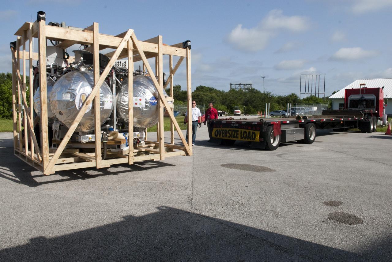CAPE CANAVERAL, Fla. - NASA's Morpheus lander, a vertical test bed vehicle, has been unloaded at the Kennedy Space Center in Florida. Morpheus is designed to demonstrate new green propellant propulsion systems and autonomous landing and an Autonomous Landing and Hazard Avoidance Technology, or ALHAT, system.      Checkout of the prototype lander has been ongoing at NASA’s Johnson Space Center in Houston in preparation for its first free flight. The SLF site will provide the lander with the kind of field necessary for realistic testing. Project Morpheus is one of 20 small projects comprising the Advanced Exploration Systems, or AES, program in NASA’s Human Exploration and Operations Mission Directorate. AES projects pioneer new approaches for rapidly developing prototype systems, demonstrating key capabilities and validating operational concepts for future human missions beyond Earth orbit. For more information on Project Morpheus, visit http://www.nasa.gov/centers/johnson/exploration/morpheus/index.html  Photo credit: NASA/ Charisse Nahser