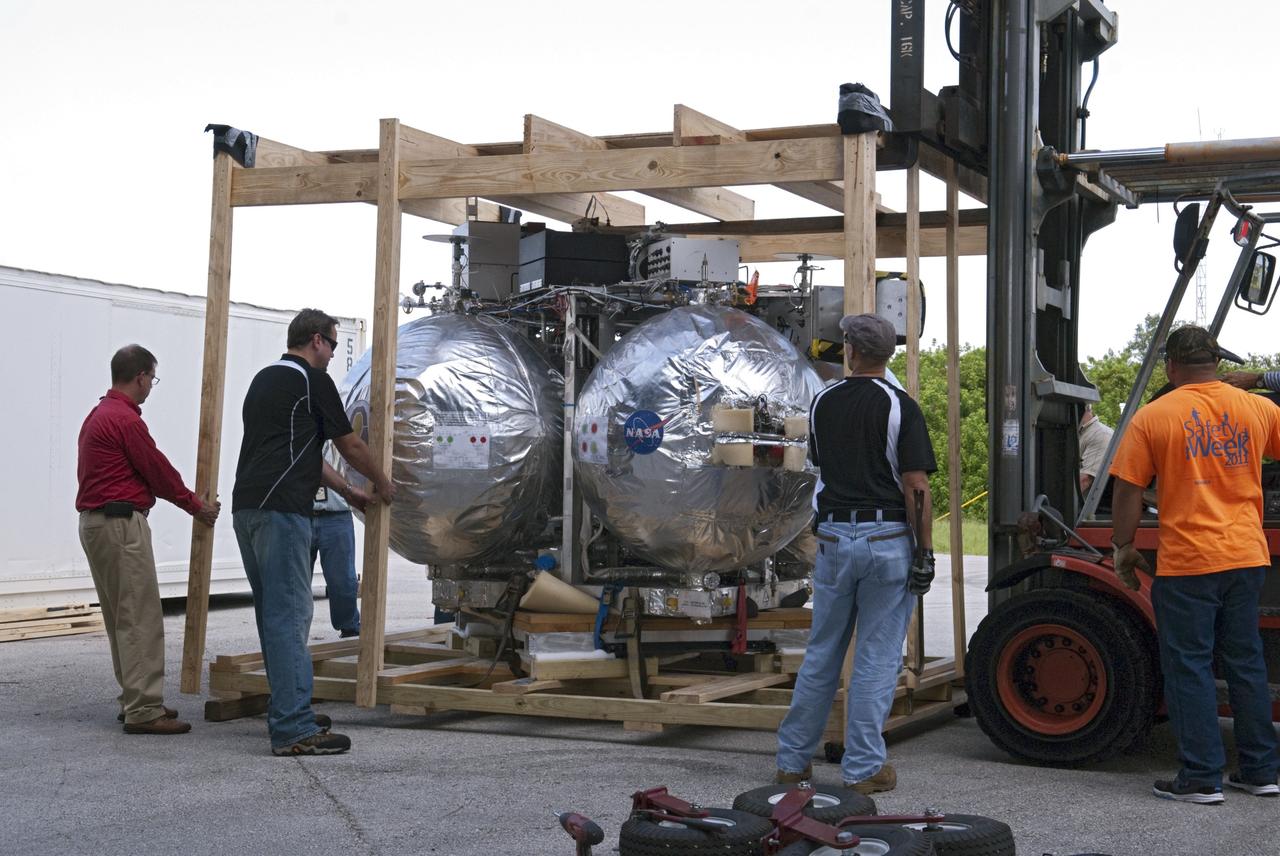 CAPE CANAVERAL, Fla. - NASA's Morpheus lander, a vertical test bed vehicle, is uncrated after unloading at the Kennedy Space Center in Florida. Morpheus is designed to demonstrate new green propellant propulsion systems and autonomous landing and an Autonomous Landing and Hazard Avoidance Technology, or ALHAT, system.      Checkout of the prototype lander has been ongoing at NASA’s Johnson Space Center in Houston in preparation for its first free flight. The SLF site will provide the lander with the kind of field necessary for realistic testing. Project Morpheus is one of 20 small projects comprising the Advanced Exploration Systems, or AES, program in NASA’s Human Exploration and Operations Mission Directorate. AES projects pioneer new approaches for rapidly developing prototype systems, demonstrating key capabilities and validating operational concepts for future human missions beyond Earth orbit. For more information on Project Morpheus, visit http://www.nasa.gov/centers/johnson/exploration/morpheus/index.html  Photo credit: NASA/ Charisse Nahser