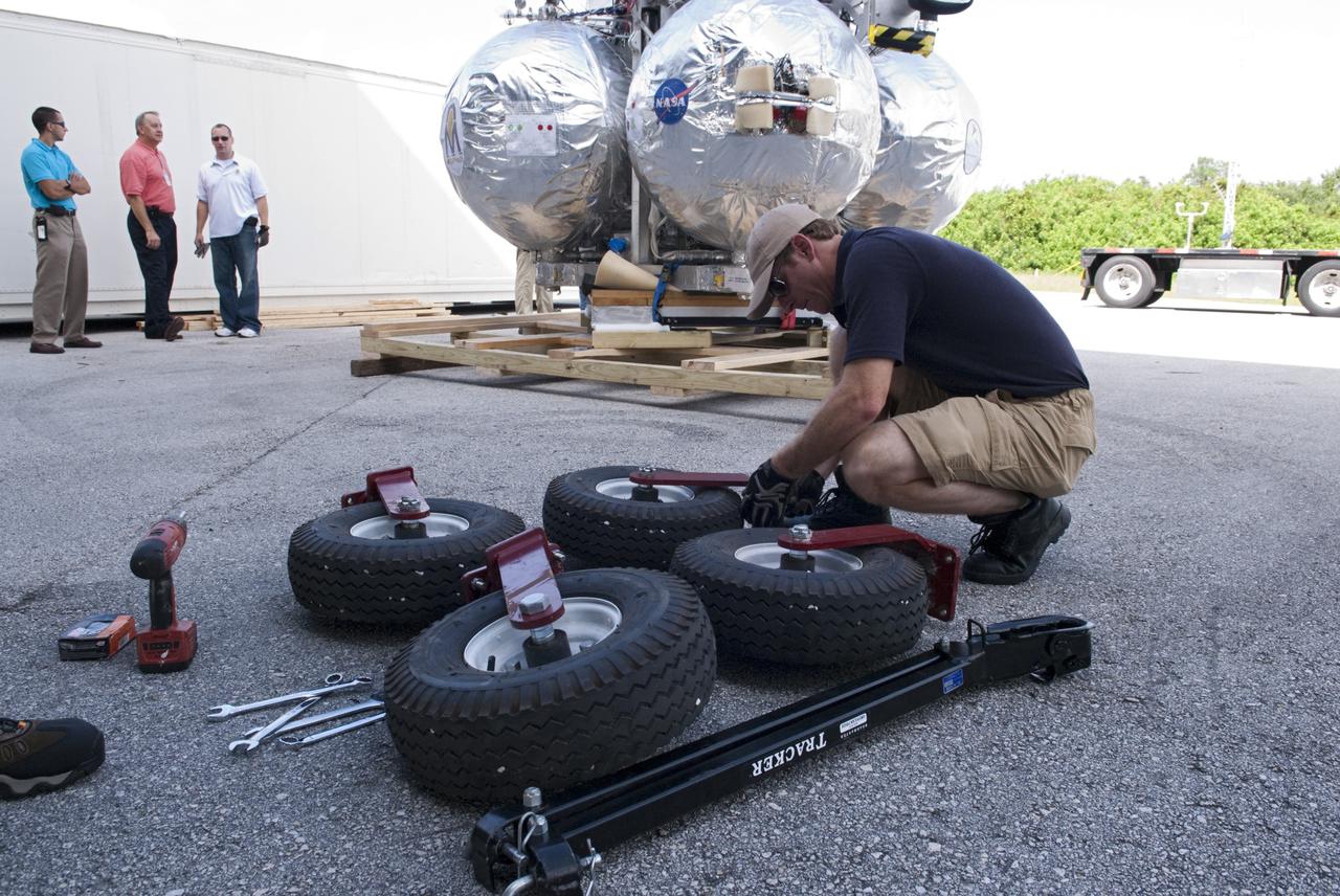 CAPE CANAVERAL, Fla. - Wheels are assembled for transporting NASA's Morpheus lander, a vertical test bed vehicle after its arrival at the Kennedy Space Center in Florida. Morpheus is designed to demonstrate new green propellant propulsion systems and autonomous landing and an Autonomous Landing and Hazard Avoidance Technology, or ALHAT, system.      Checkout of the prototype lander has been ongoing at NASA’s Johnson Space Center in Houston in preparation for its first free flight. The SLF site will provide the lander with the kind of field necessary for realistic testing. Project Morpheus is one of 20 small projects comprising the Advanced Exploration Systems, or AES, program in NASA’s Human Exploration and Operations Mission Directorate. AES projects pioneer new approaches for rapidly developing prototype systems, demonstrating key capabilities and validating operational concepts for future human missions beyond Earth orbit. For more information on Project Morpheus, visit http://www.nasa.gov/centers/johnson/exploration/morpheus/index.html  Photo credit: NASA/ Charisse Nahser