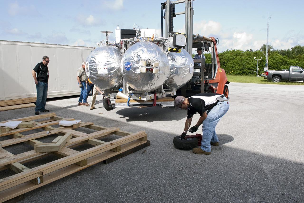 CAPE CANAVERAL, Fla. - Wheels are assembled for transporting NASA's Morpheus lander, a vertical test bed vehicle after its arrival at the Kennedy Space Center in Florida. Morpheus is designed to demonstrate new green propellant propulsion systems and autonomous landing and an Autonomous Landing and Hazard Avoidance Technology, or ALHAT, system.      Checkout of the prototype lander has been ongoing at NASA’s Johnson Space Center in Houston in preparation for its first free flight. The SLF site will provide the lander with the kind of field necessary for realistic testing. Project Morpheus is one of 20 small projects comprising the Advanced Exploration Systems, or AES, program in NASA’s Human Exploration and Operations Mission Directorate. AES projects pioneer new approaches for rapidly developing prototype systems, demonstrating key capabilities and validating operational concepts for future human missions beyond Earth orbit. For more information on Project Morpheus, visit http://www.nasa.gov/centers/johnson/exploration/morpheus/index.html  Photo credit: NASA/ Charisse Nahser