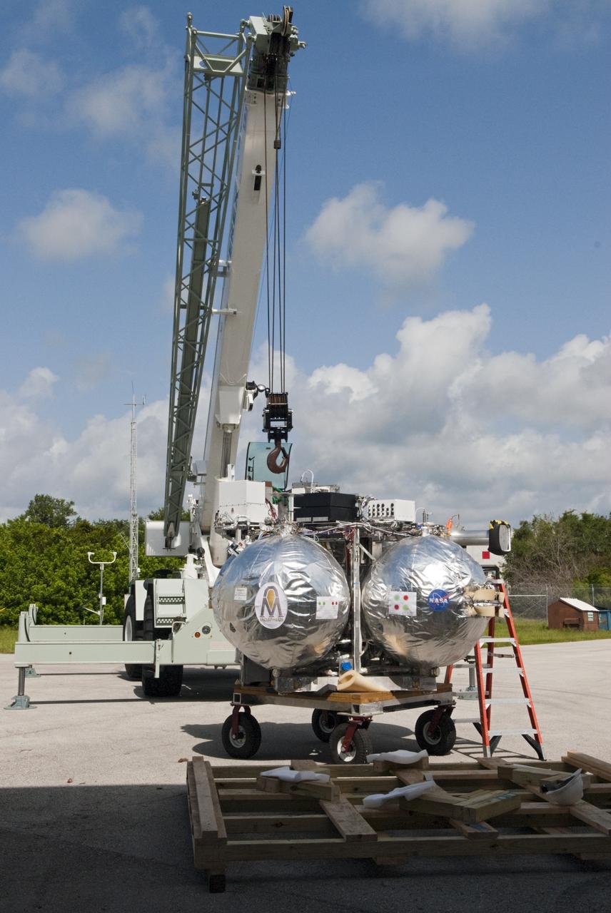 CAPE CANAVERAL, Fla. - A crane supports unloading of NASA's Morpheus lander, a vertical test bed vehicle, at the Kennedy Space Center in Florida. Morpheus is designed to demonstrate new green propellant propulsion systems and autonomous landing and an Autonomous Landing and Hazard Avoidance Technology, or ALHAT, system.      Checkout of the prototype lander has been ongoing at NASA’s Johnson Space Center in Houston in preparation for its first free flight. The SLF site will provide the lander with the kind of field necessary for realistic testing. Project Morpheus is one of 20 small projects comprising the Advanced Exploration Systems, or AES, program in NASA’s Human Exploration and Operations Mission Directorate. AES projects pioneer new approaches for rapidly developing prototype systems, demonstrating key capabilities and validating operational concepts for future human missions beyond Earth orbit. For more information on Project Morpheus, visit http://www.nasa.gov/centers/johnson/exploration/morpheus/index.html  Photo credit: NASA/ Charisse Nahser