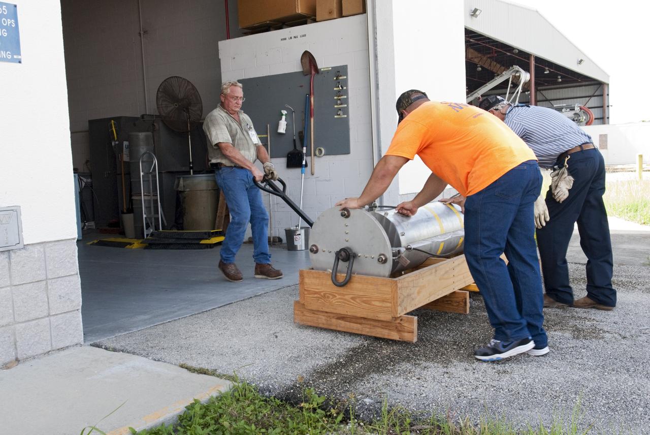 CAPE CANAVERAL, Fla. - Support equipment for NASA's Morpheus lander, a vertical test bed vehicle, is moved into a building at the Shuttle Landing Facility, or SLF, at the Kennedy Space Center in Florida. Morpheus is designed to demonstrate new green propellant propulsion systems and autonomous landing and an Autonomous Landing and Hazard Avoidance Technology, or ALHAT, system.      Checkout of the prototype lander has been ongoing at NASA’s Johnson Space Center in Houston in preparation for its first free flight. The SLF site will provide the lander with the kind of field necessary for realistic testing. Project Morpheus is one of 20 small projects comprising the Advanced Exploration Systems, or AES, program in NASA’s Human Exploration and Operations Mission Directorate. AES projects pioneer new approaches for rapidly developing prototype systems, demonstrating key capabilities and validating operational concepts for future human missions beyond Earth orbit. For more information on Project Morpheus, visit http://www.nasa.gov/centers/johnson/exploration/morpheus/index.html  Photo credit: NASA/ Charisse Nahser