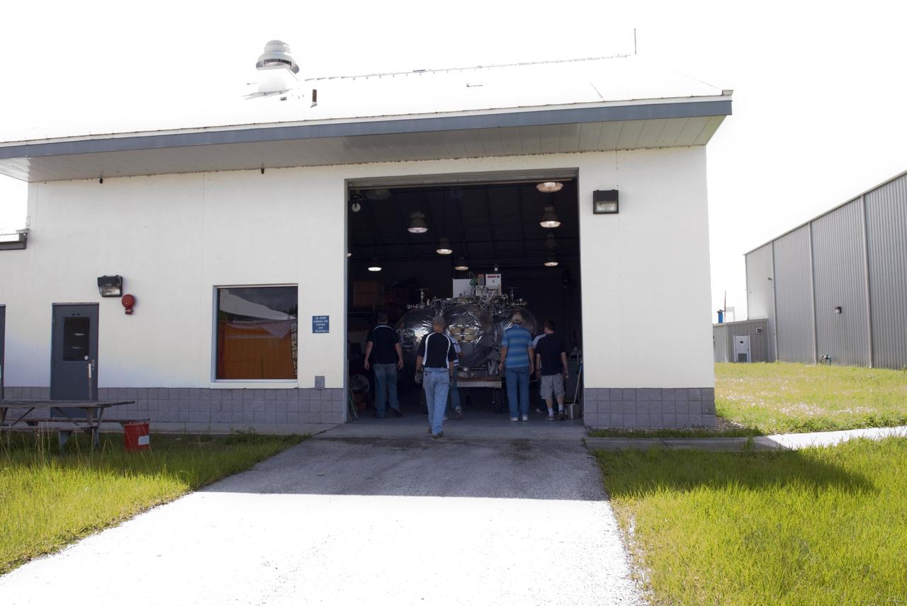 CAPE CANAVERAL, Fla. - NASA's Morpheus lander, a vertical test bed vehicle, has been moved into a building at the Shuttle Landing Facility, or SLF, at the Kennedy Space Center in Florida. Morpheus is designed to demonstrate new green propellant propulsion systems and autonomous landing and an Autonomous Landing and Hazard Avoidance Technology, or ALHAT, system.      Checkout of the prototype lander has been ongoing at NASA’s Johnson Space Center in Houston in preparation for its first free flight. The SLF site will provide the lander with the kind of field necessary for realistic testing. Project Morpheus is one of 20 small projects comprising the Advanced Exploration Systems, or AES, program in NASA’s Human Exploration and Operations Mission Directorate. AES projects pioneer new approaches for rapidly developing prototype systems, demonstrating key capabilities and validating operational concepts for future human missions beyond Earth orbit. For more information on Project Morpheus, visit http://www.nasa.gov/centers/johnson/exploration/morpheus/index.html  Photo credit: NASA/ Charisse Nahser