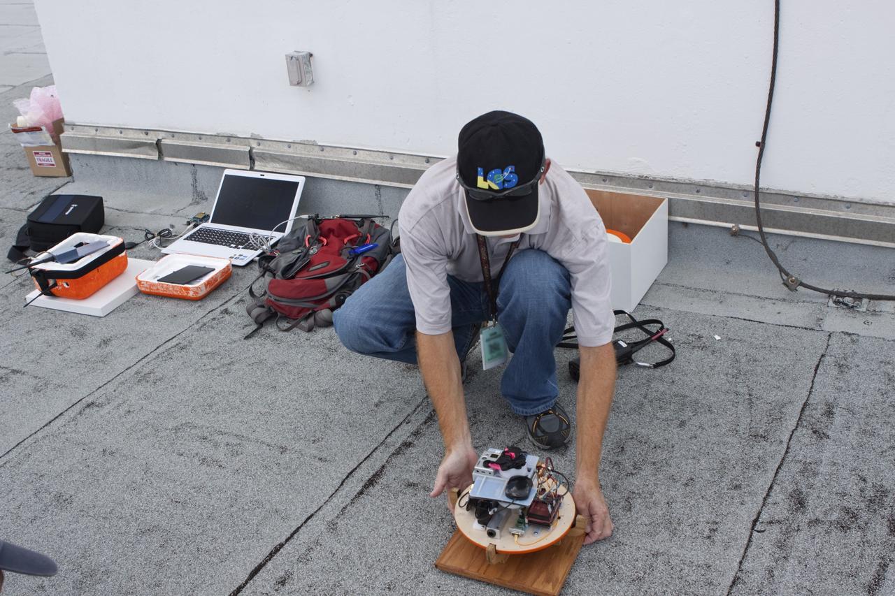 CAPE CANAVERAL, Fla. – Karl Stolleis prepares an instrument package for testing as part of a high-altitude balloon flight for the Rocket University program. The test flight was used to evaluate the stability of an instrumented capsule as it fell to Earth before its parachute opened. Rocket University is a program of courses, workshops, labs and projects offered to engineering and research pros of all stripes to keep their skills fresh and broaden their experiences. Photo credit: NASA/Jim Grossmann