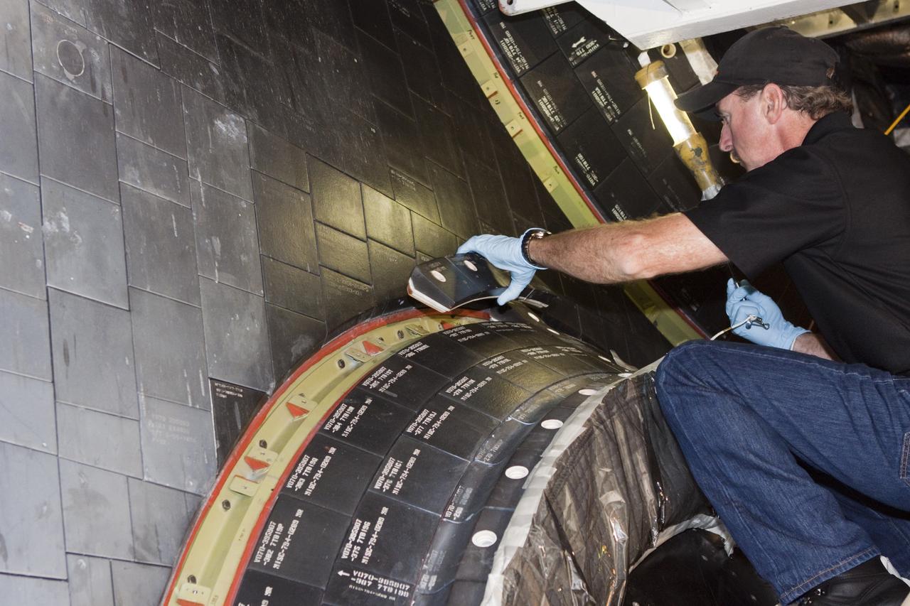 CAPE CANAVERAL, Fla. – In Orbiter Processing Facility Bay 2 at NASA’s Kennedy Space Center in Florida, United Space Alliance aerospace technician Chris Peluso installs a heat shield carrier panel on the space shuttle Endeavour.      The work is part of Transition and Retirement of the remaining space shuttles, Endeavour and Atlantis. Endeavour is being prepared for public display at the California Science Center in Los Angeles. Its ferry flight to California is targeted for mid-September. Endeavour was the last space shuttle added to NASA’s orbiter fleet. Over the course of its 19-year career, Endeavour spent 299 days in space during 25 missions. For more information, visit http://www.nasa.gov/transition Photo credit: NASA/ Jim Grossmann