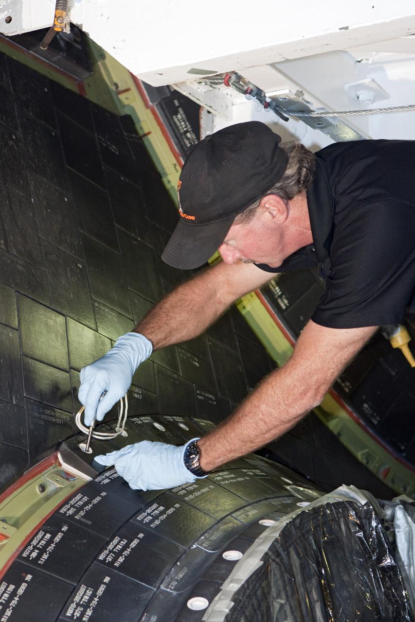 CAPE CANAVERAL, Fla. – In Orbiter Processing Facility Bay 2 at NASA’s Kennedy Space Center in Florida, United Space Alliance aerospace technician Chris Peluso installs a heat shield carrier panel on the space shuttle Endeavour.      The work is part of Transition and Retirement of the remaining space shuttles, Endeavour and Atlantis. Endeavour is being prepared for public display at the California Science Center in Los Angeles. Its ferry flight to California is targeted for mid-September. Endeavour was the last space shuttle added to NASA’s orbiter fleet. Over the course of its 19-year career, Endeavour spent 299 days in space during 25 missions. For more information, visit http://www.nasa.gov/transition Photo credit: NASA/ Jim Grossmann