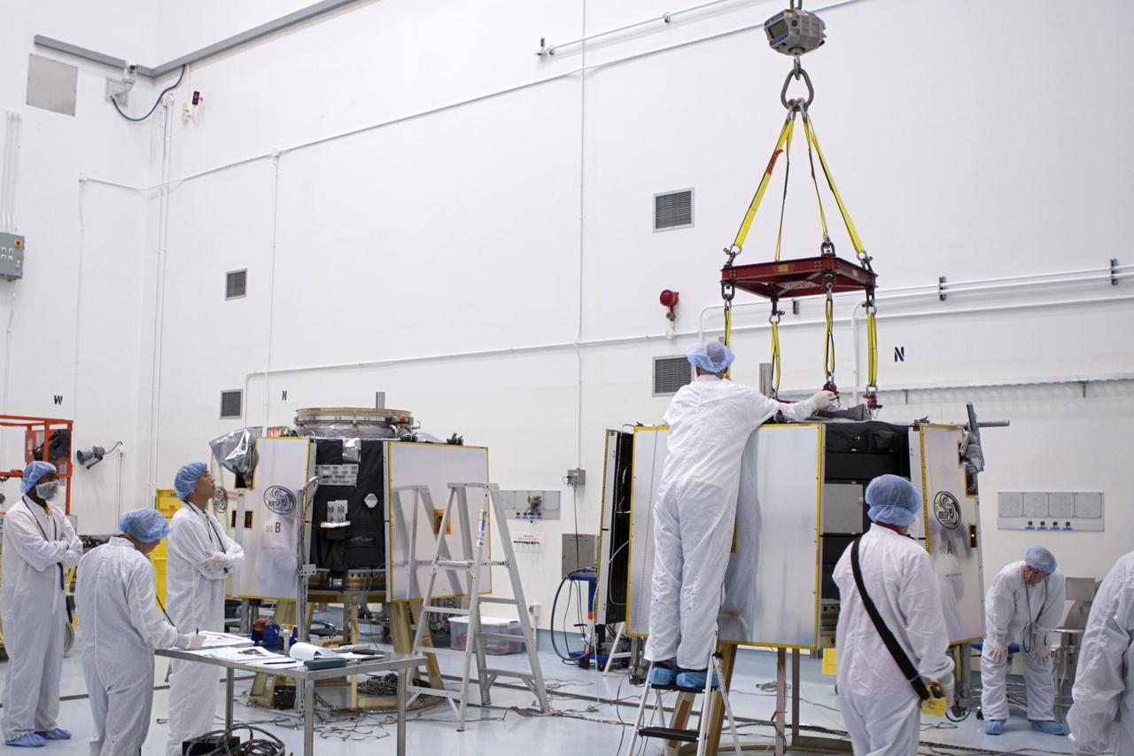 TITUSVILLE, Fla. - Inside the Astrotech payload processing facility in Titusville, Fla. near NASA’s Kennedy Space Center, technicians attach a crane to the Radiation Belt Storm Probes, or RBSP, spacecraft A prior to vertical stacking atop RBSP B. NASA’s RBSP mission will help us understand the sun’s influence on Earth and near-Earth space by studying the Earth’s radiation belts on various scales of space and time. RBSP will begin its mission of exploration of Earth’s Van Allen radiation belts and the extremes of space weather after its liftoff aboard a United Launch Alliance Atlas V from Space Launch Complex 41 at Cape Canaveral Air Force Station, Fla. Liftoff is targeted for Aug. 23, 2012. For more information, visit http://www.nasa.gov/rbsp. Photo credit: NASA/Jim Grossmann