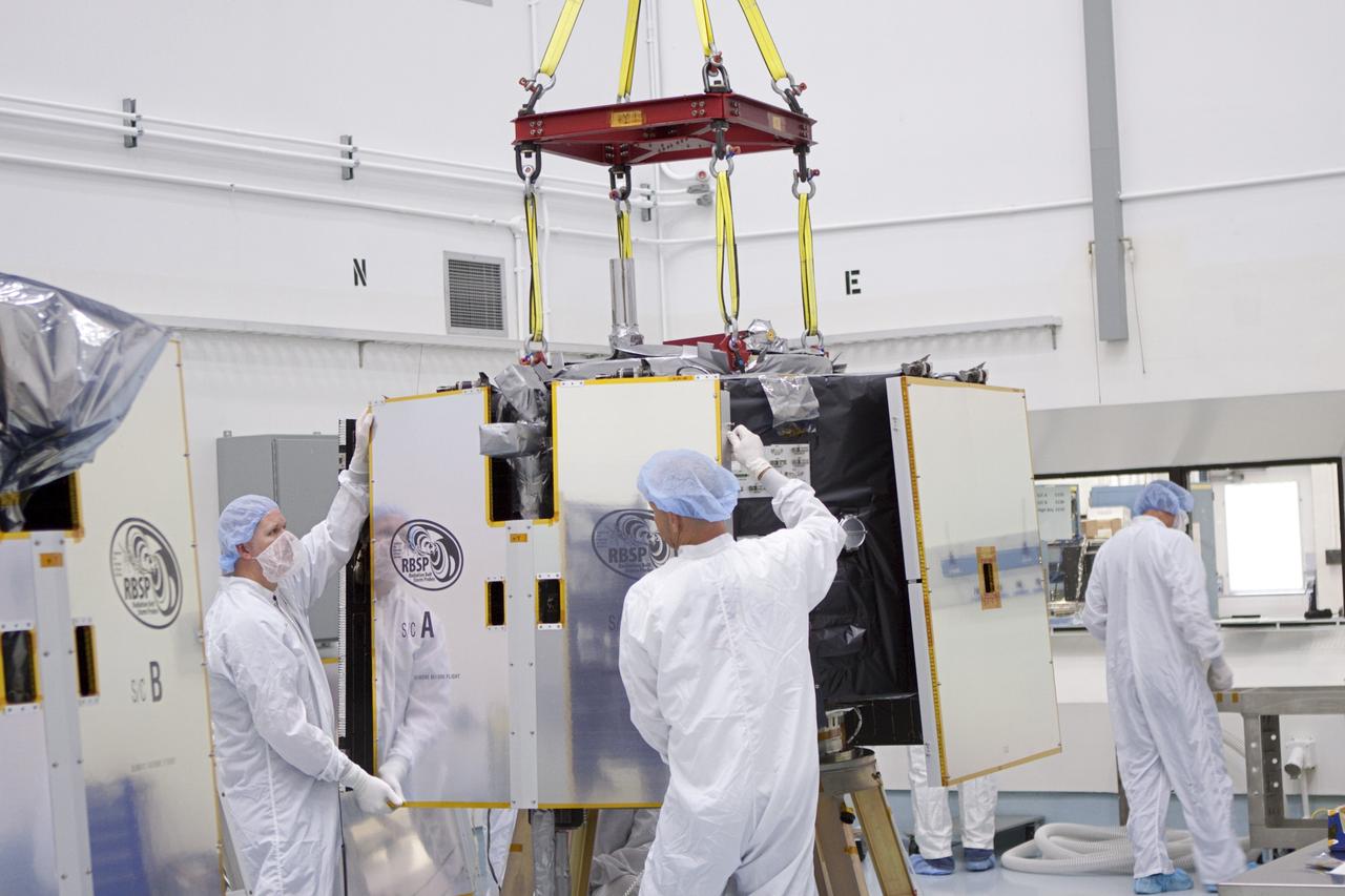 TITUSVILLE, Fla. - Inside the Astrotech payload processing facility in Titusville, Fla. near NASA’s Kennedy Space Center, technicians remove covers after a crane was attached to the Radiation Belt Storm Probes, or RBSP, spacecraft A prior to vertical stacking atop RBSP B. NASA’s RBSP mission will help us understand the sun’s influence on Earth and near-Earth space by studying the Earth’s radiation belts on various scales of space and time. RBSP will begin its mission of exploration of Earth’s Van Allen radiation belts and the extremes of space weather after its liftoff aboard a United Launch Alliance Atlas V from Space Launch Complex 41 at Cape Canaveral Air Force Station, Fla. Liftoff is targeted for Aug. 23, 2012. For more information, visit http://www.nasa.gov/rbsp. Photo credit: NASA/Jim Grossmann
