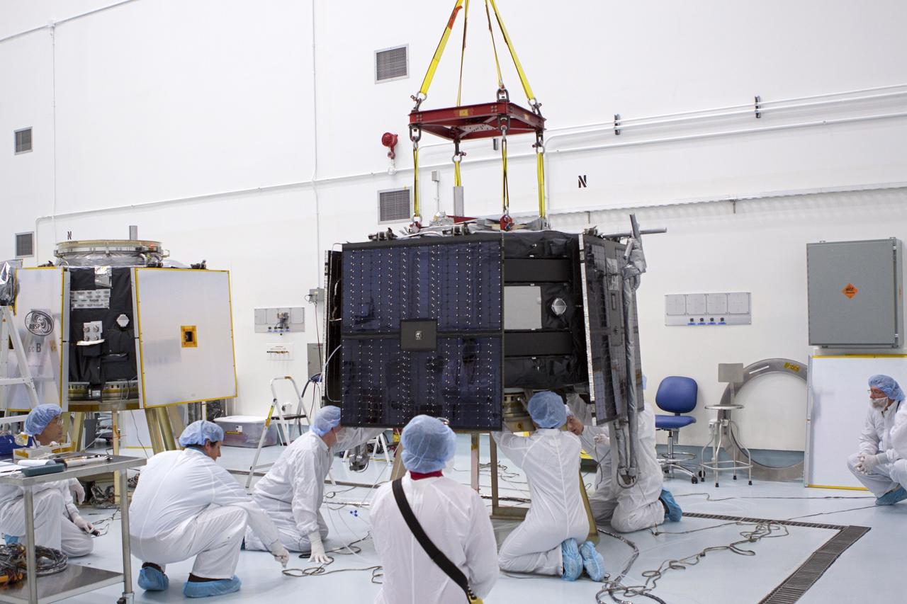 TITUSVILLE, Fla. - Inside the Astrotech payload processing facility in Titusville, Fla. near NASA’s Kennedy Space Center, technicians prepare the Radiation Belt Storm Probes, or RBSP, spacecraft A prior to vertical stacking atop RBSP B. NASA’s RBSP mission will help us understand the sun’s influence on Earth and near-Earth space by studying the Earth’s radiation belts on various scales of space and time. RBSP will begin its mission of exploration of Earth’s Van Allen radiation belts and the extremes of space weather after its liftoff aboard a United Launch Alliance Atlas V from Space Launch Complex 41 at Cape Canaveral Air Force Station, Fla. Liftoff is targeted for Aug. 23, 2012. For more information, visit http://www.nasa.gov/rbsp. Photo credit: NASA/Jim Grossmann